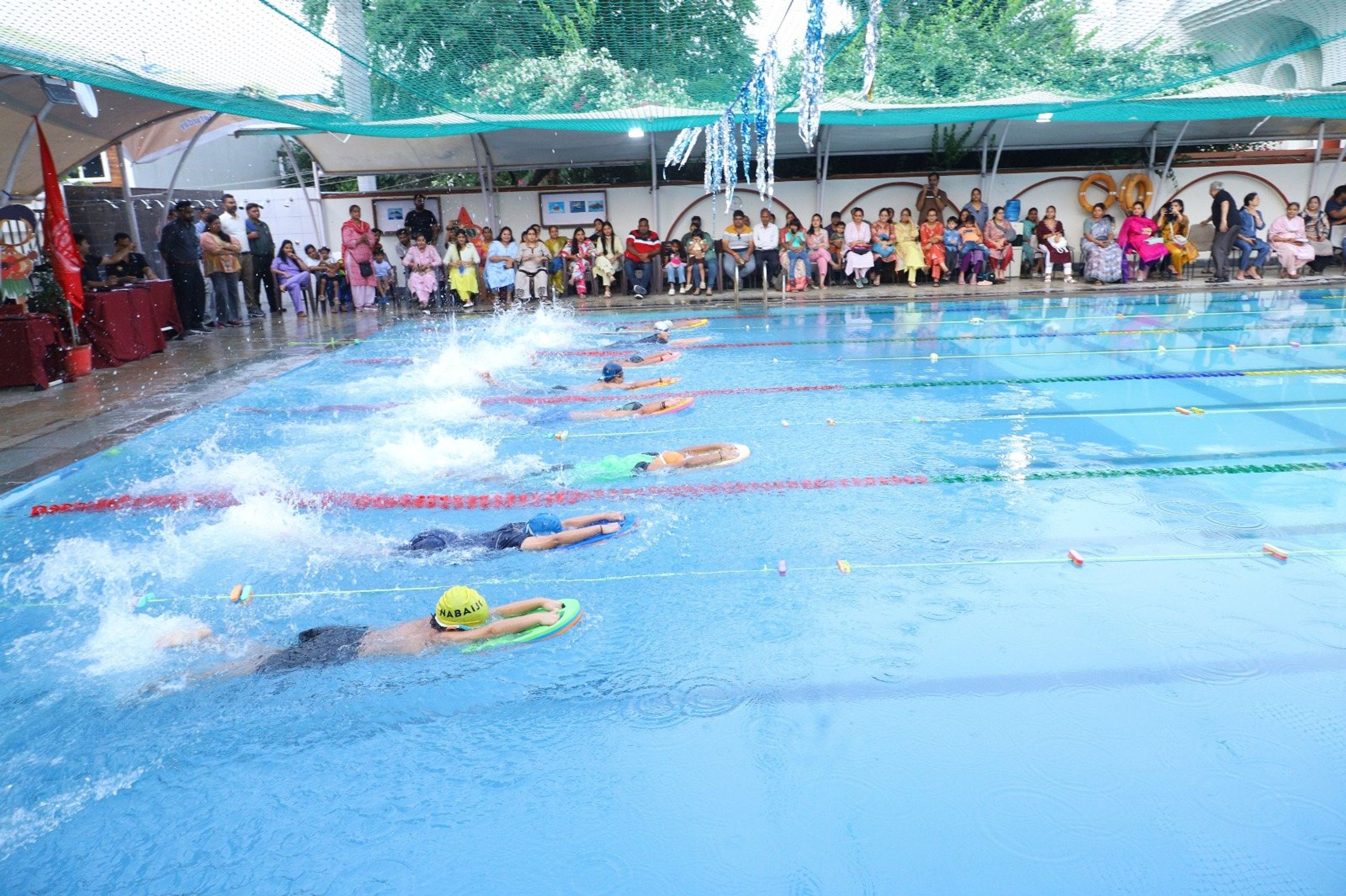 Swimmers racing at a gala in the school pool
