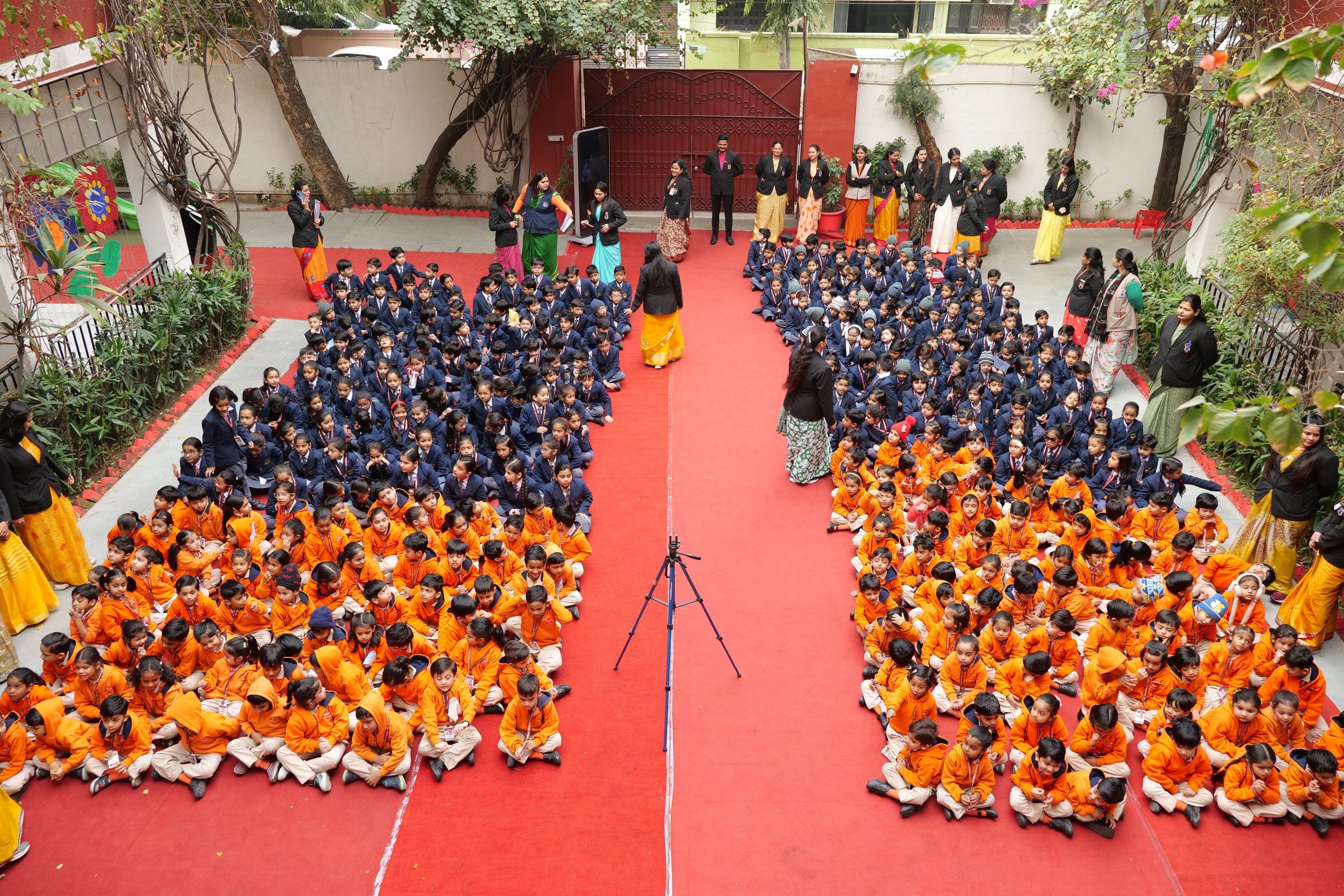 The whole school seated in the courtyard for a special assembly