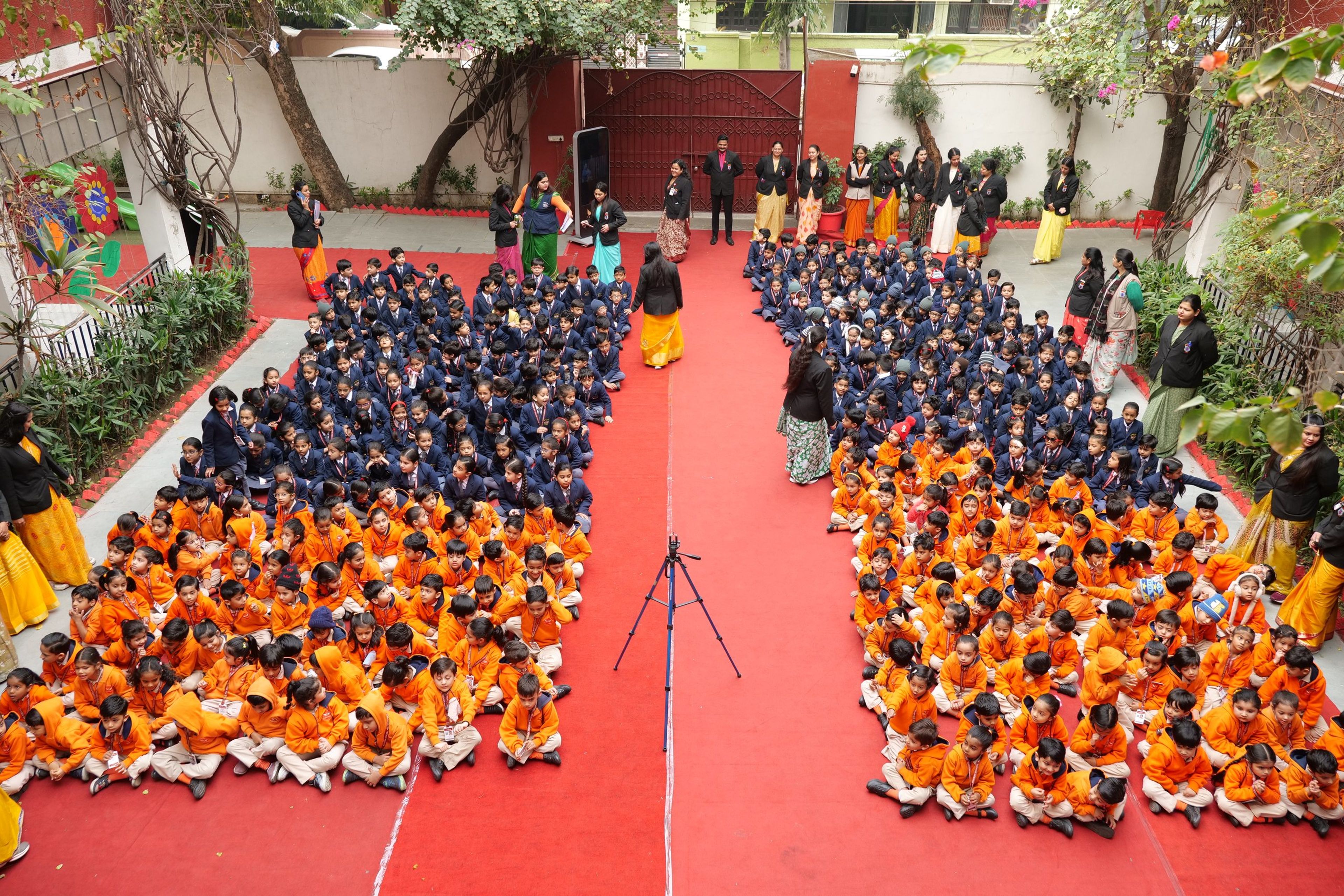 The whole school seated in the courtyard for a special assembly