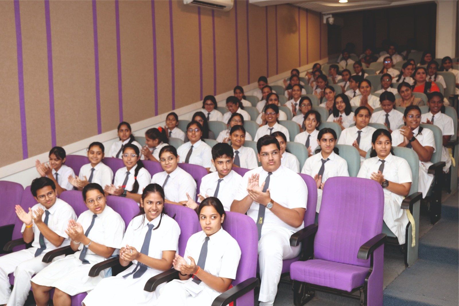 Senior students applauding in the auditorium