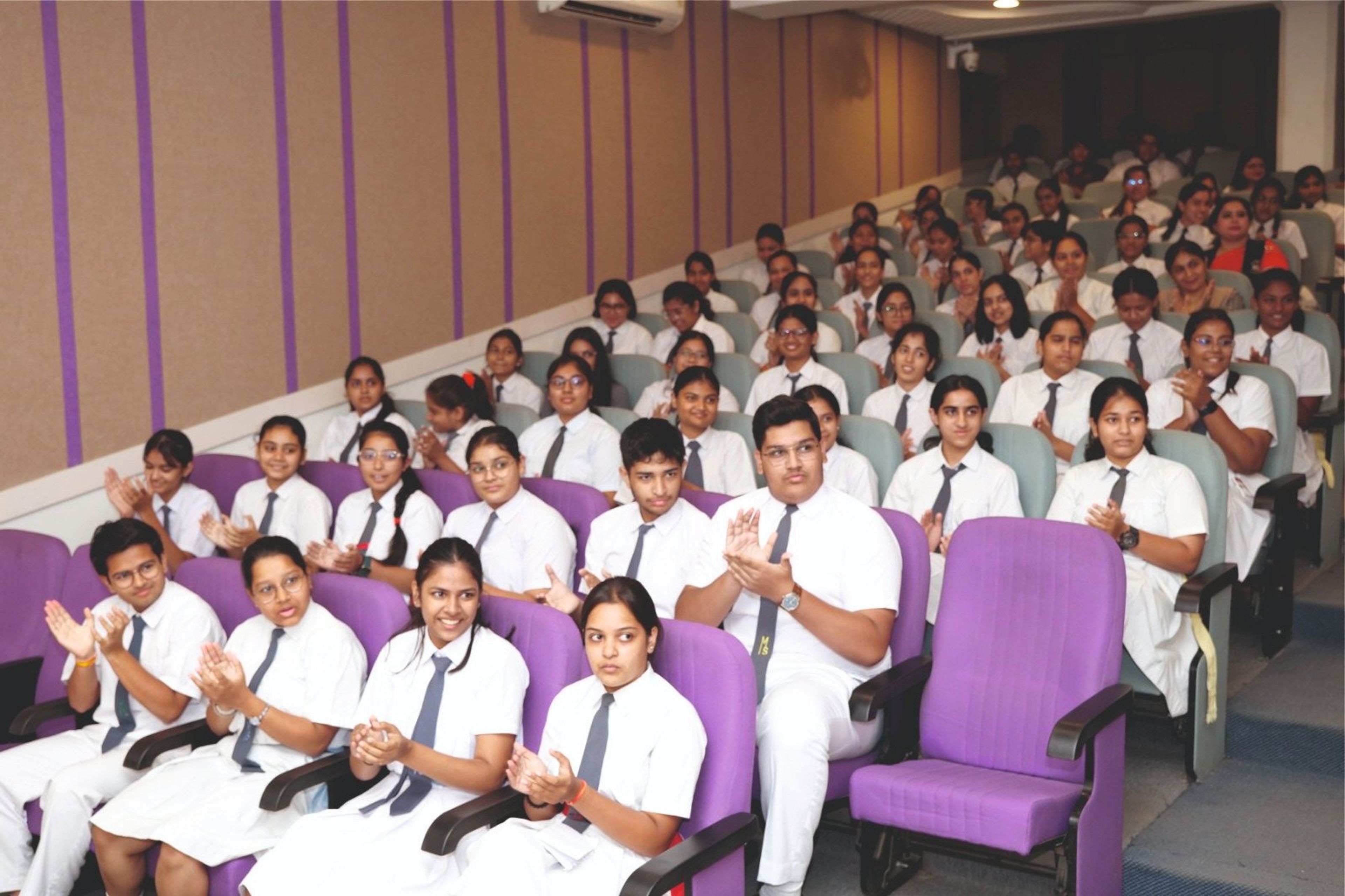 Senior students applauding in the auditorium