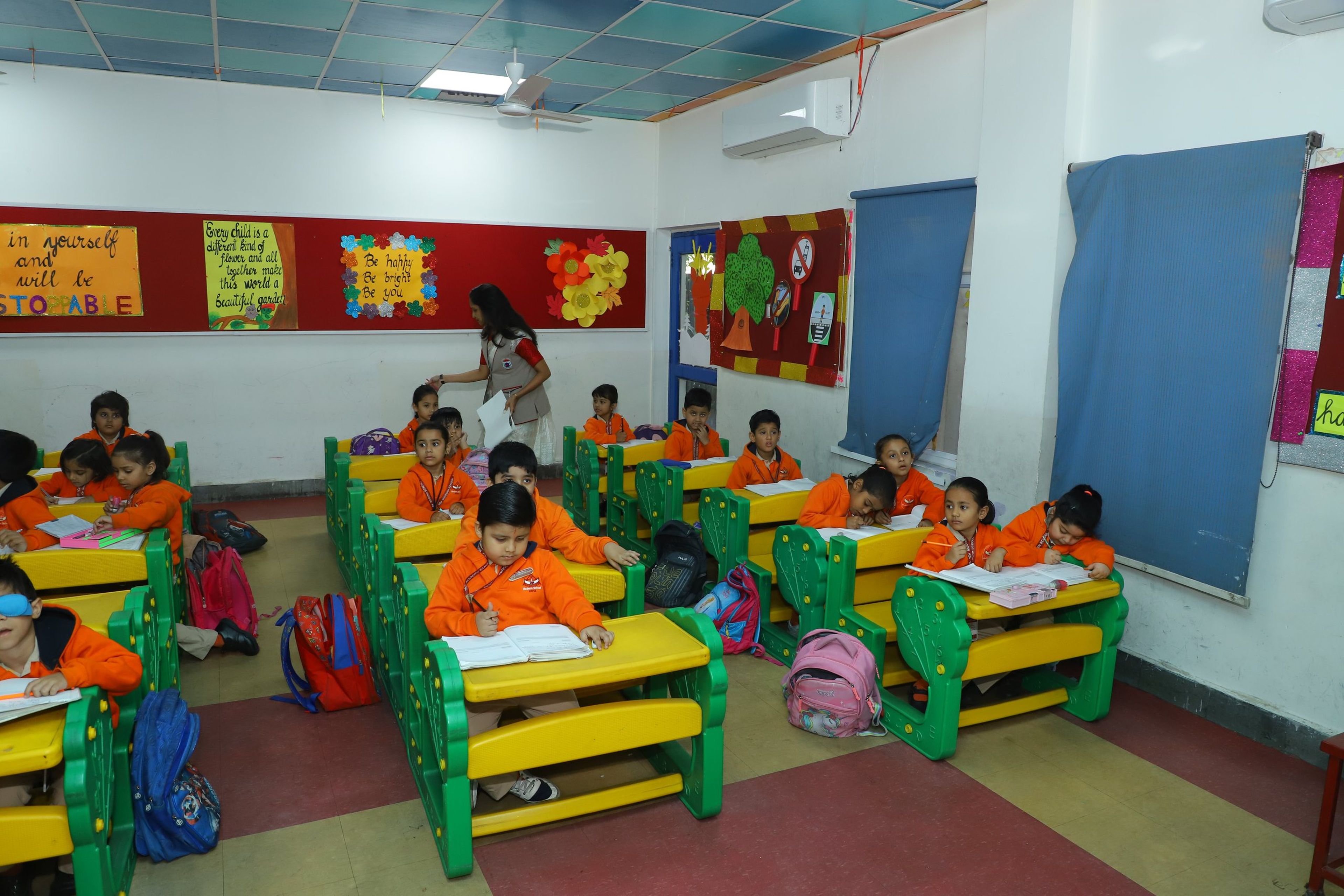 A bright pre-primary classroom with children at their desks