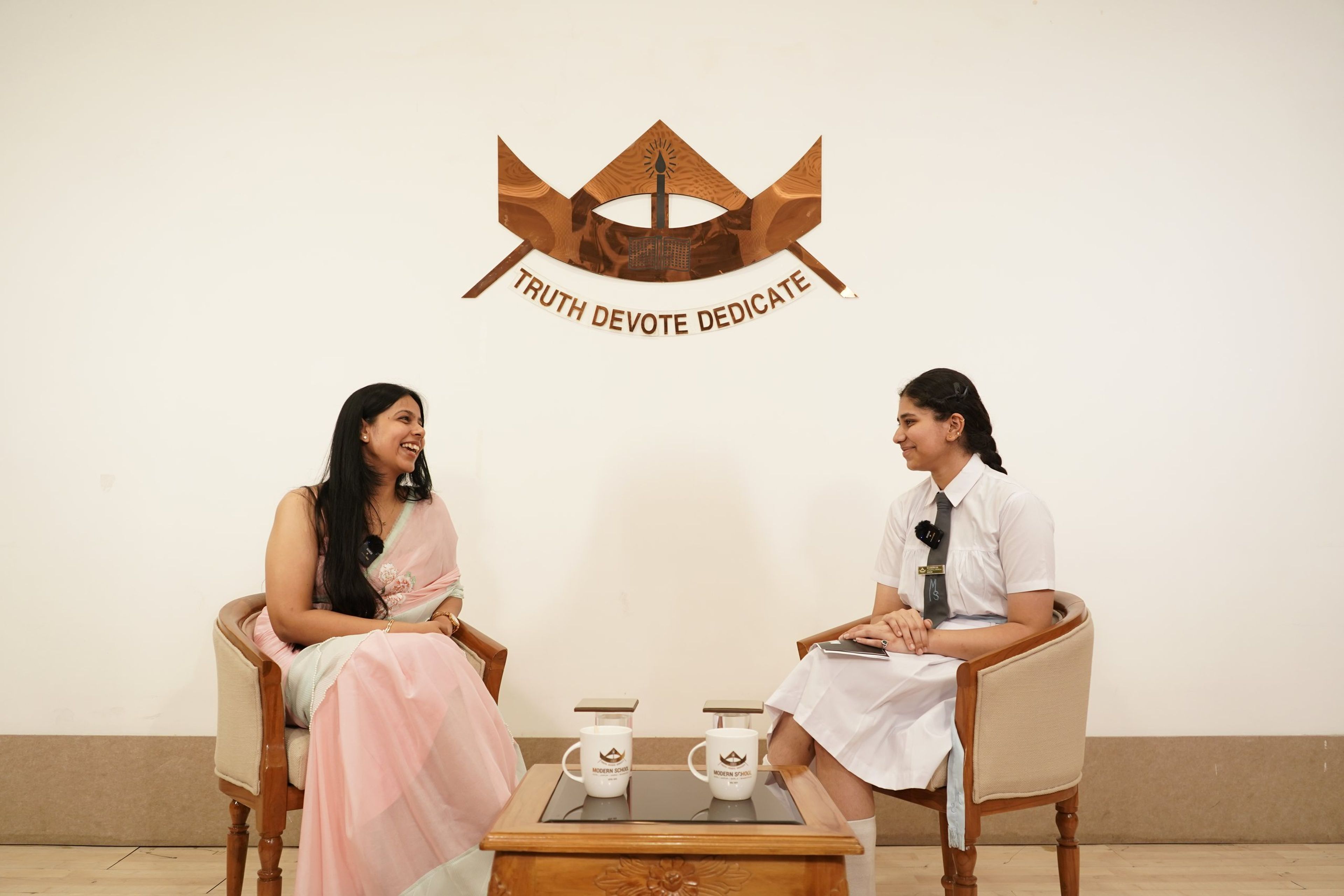 A teacher and a student in conversation on the podcast set