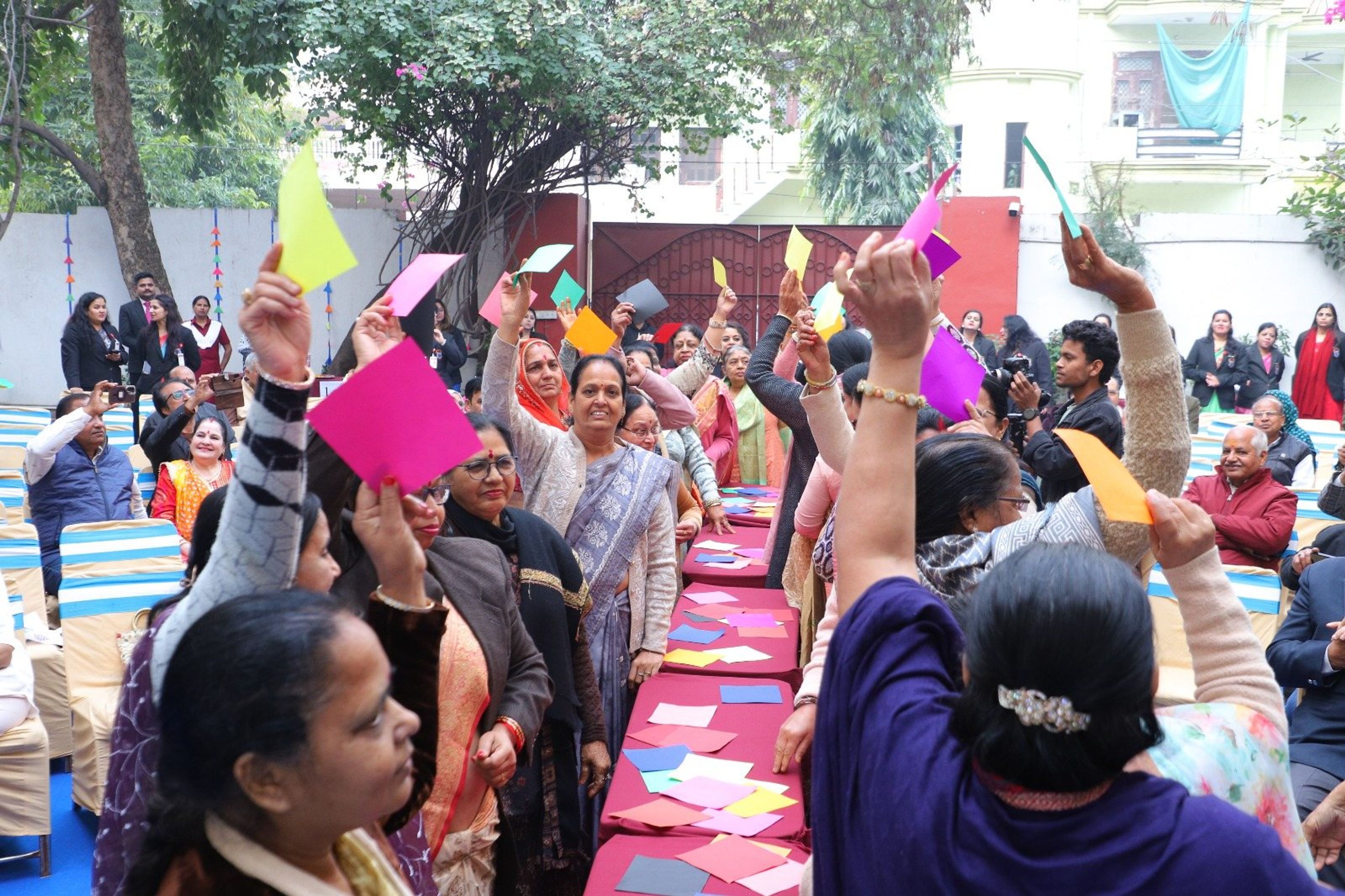 Guests raising coloured cards during the celebration