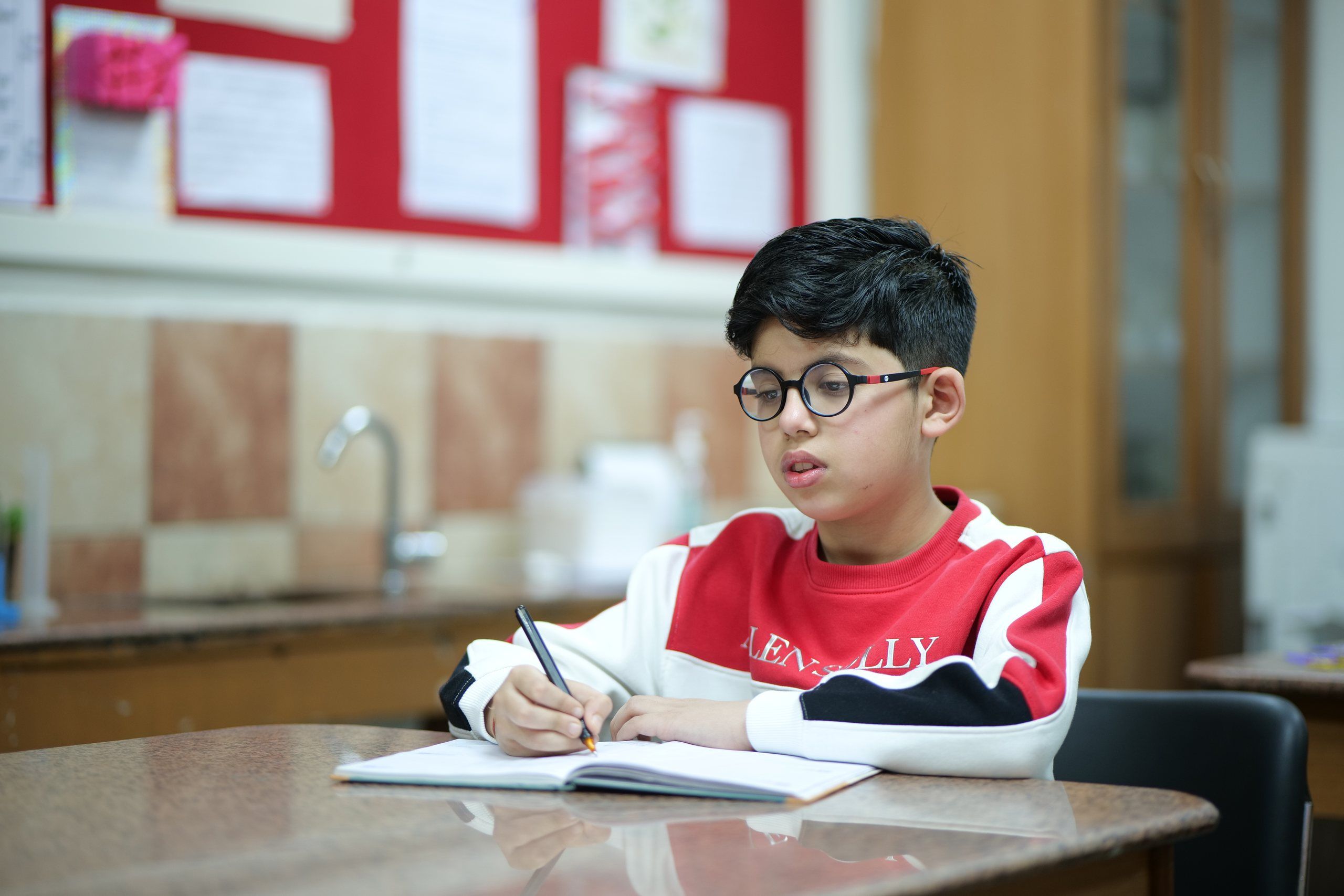 A student writing in his notebook