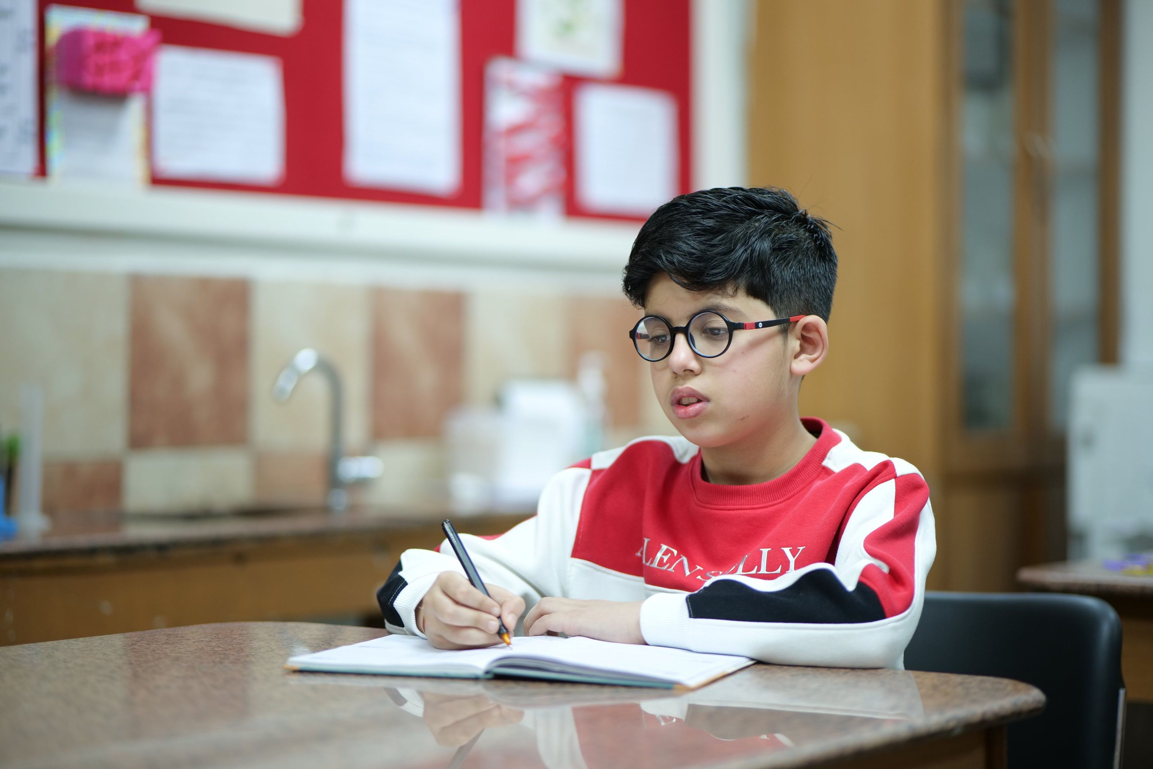 A student writing in his notebook