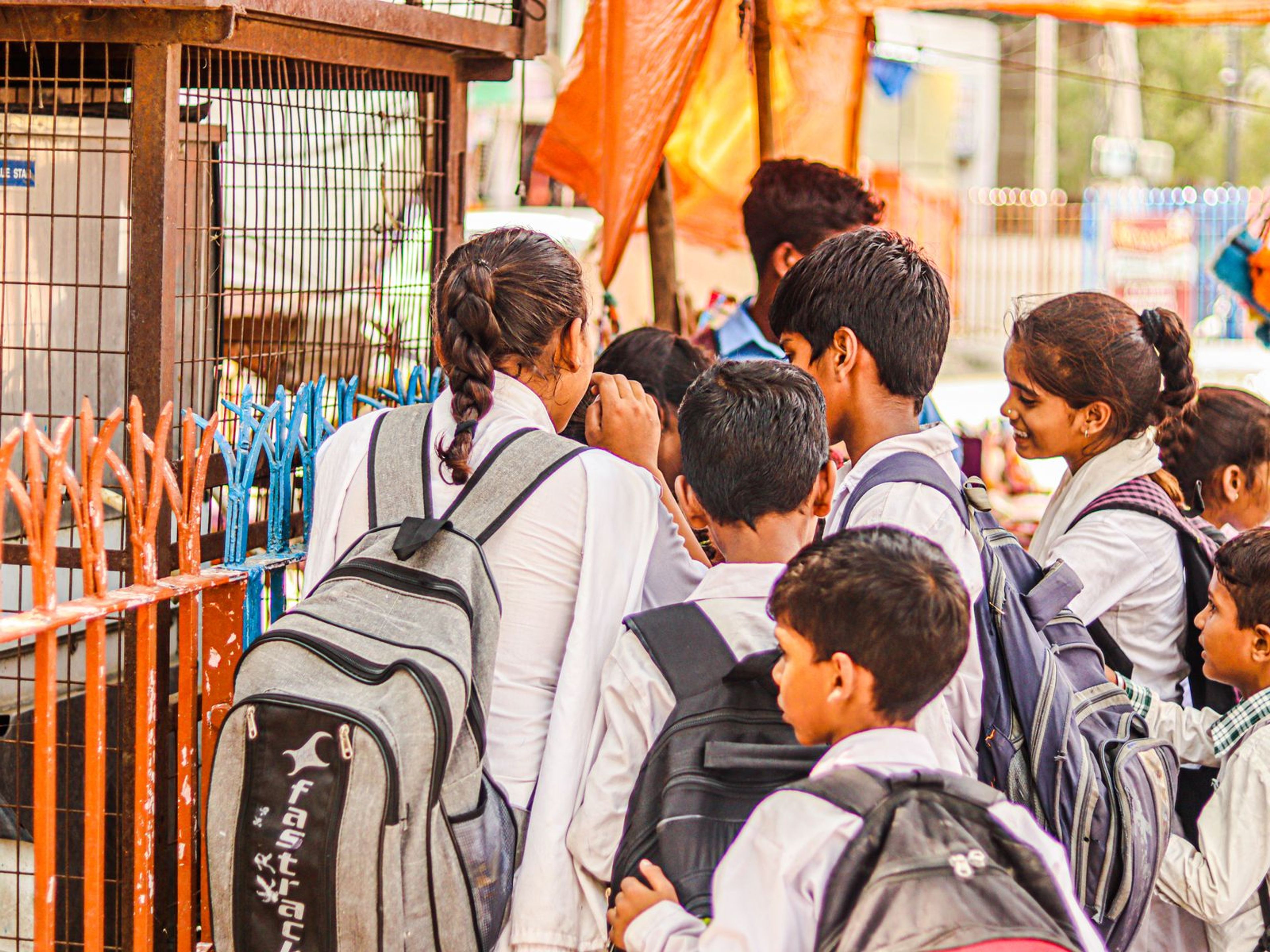 Children with backpacks outdoors on a school outing