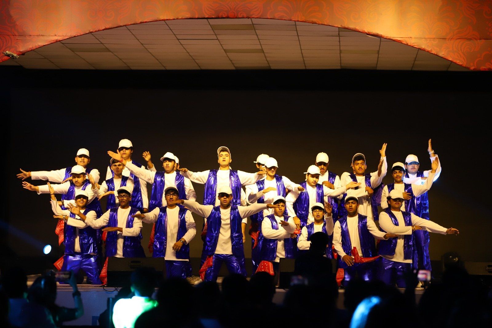 Students performing a group dance on stage