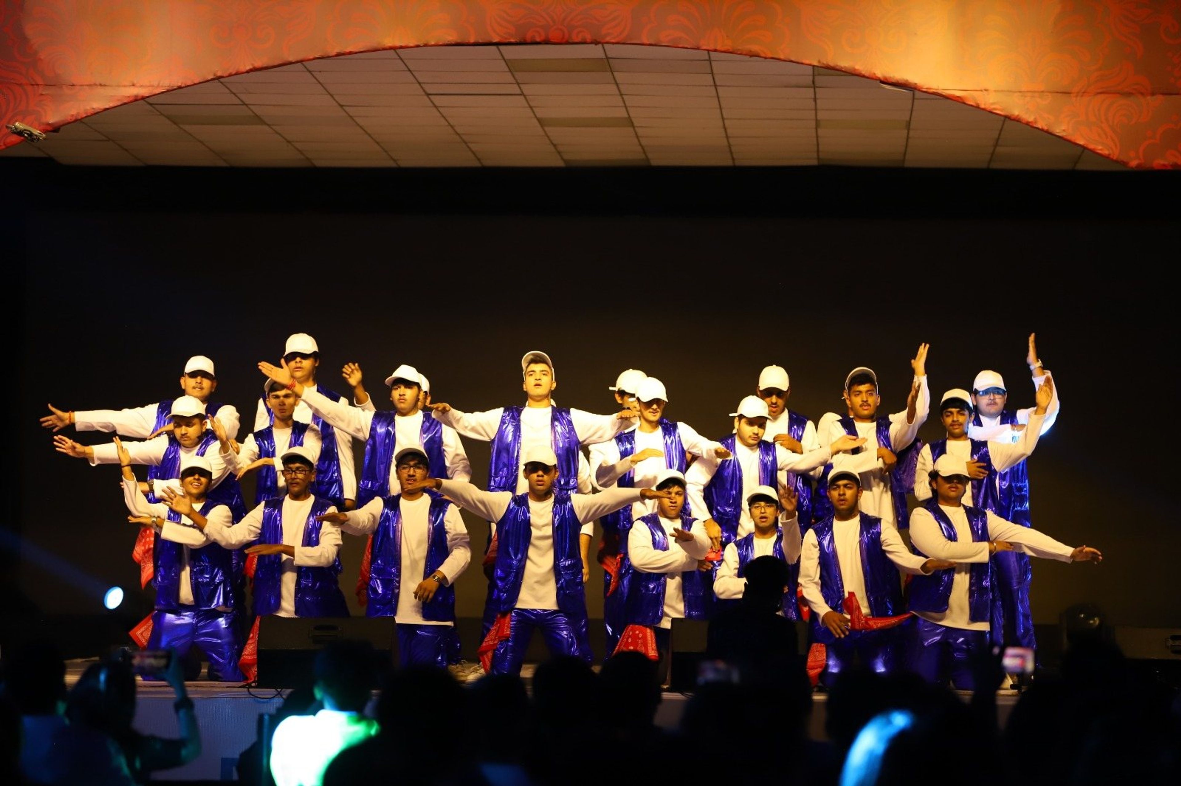 Students performing a group dance on stage