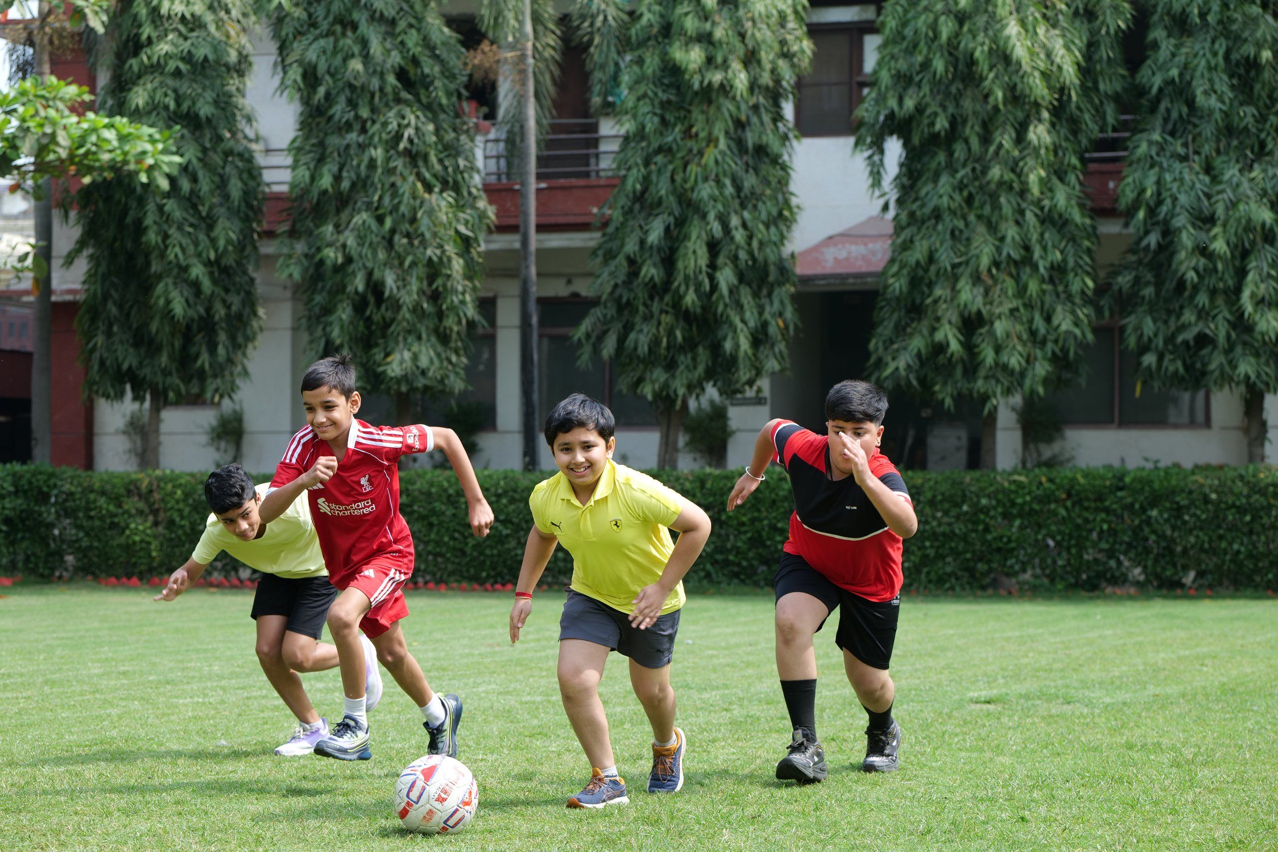 Students playing football on the school lawn