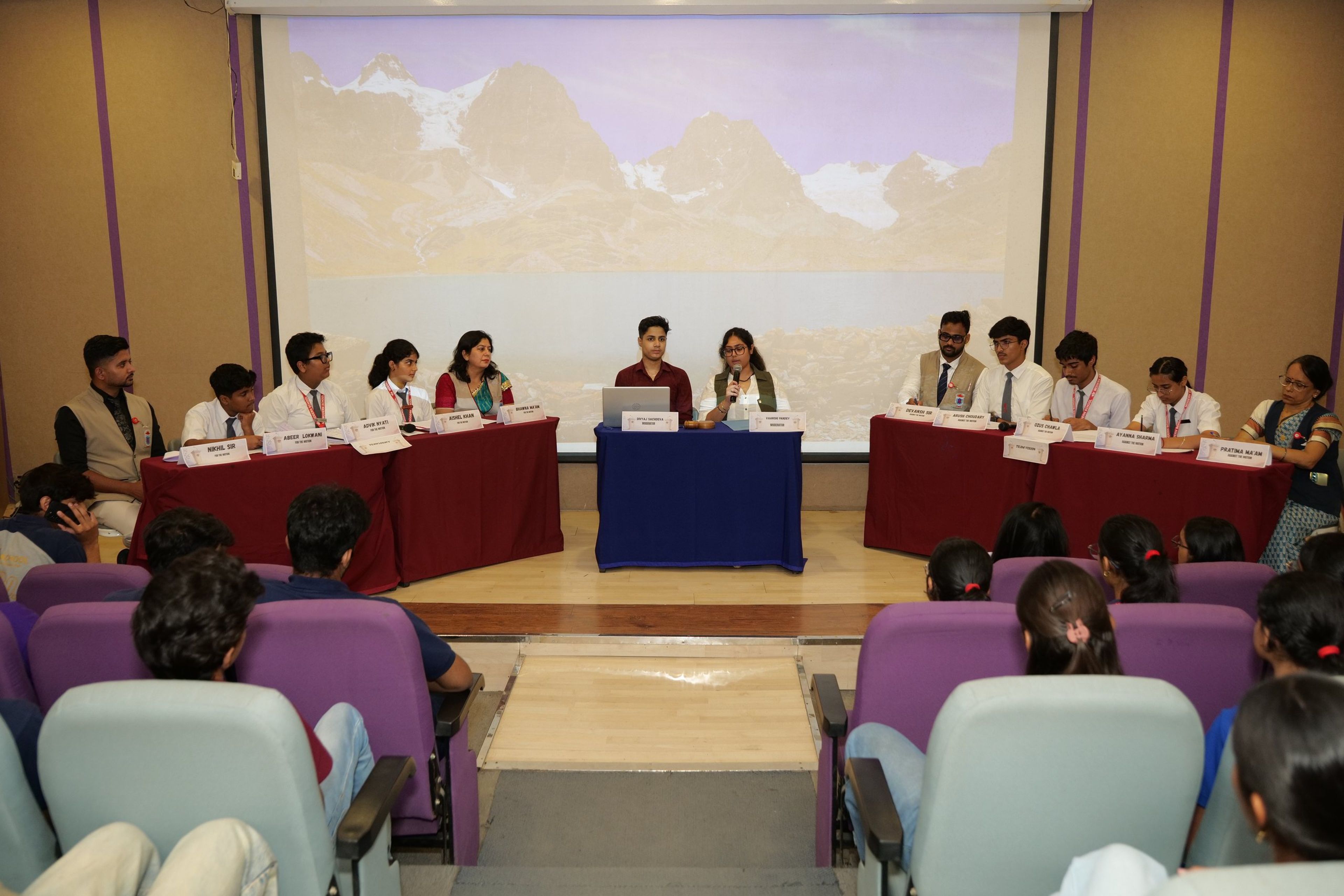Debate teams and judges in the auditorium