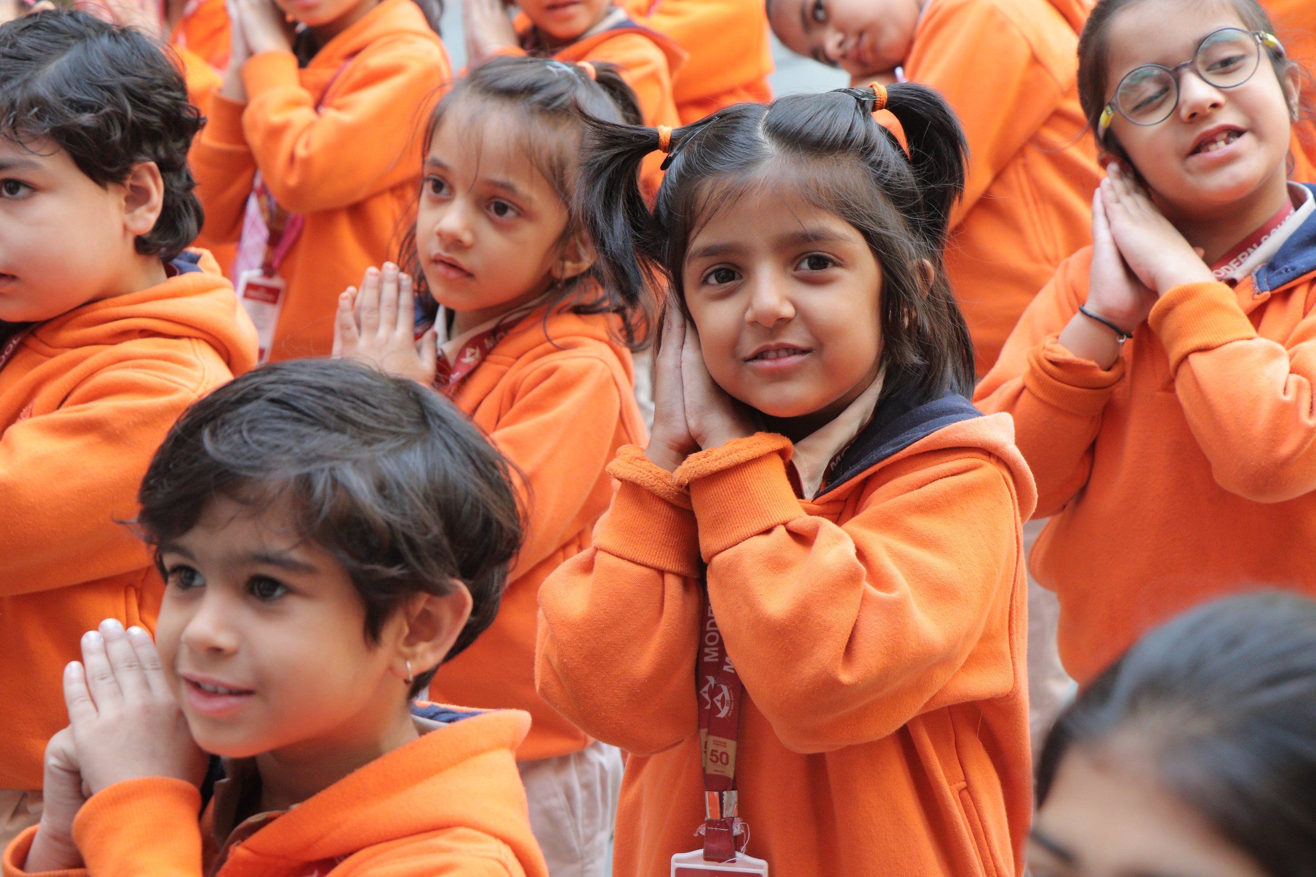 Young pupils with folded hands at the morning assembly