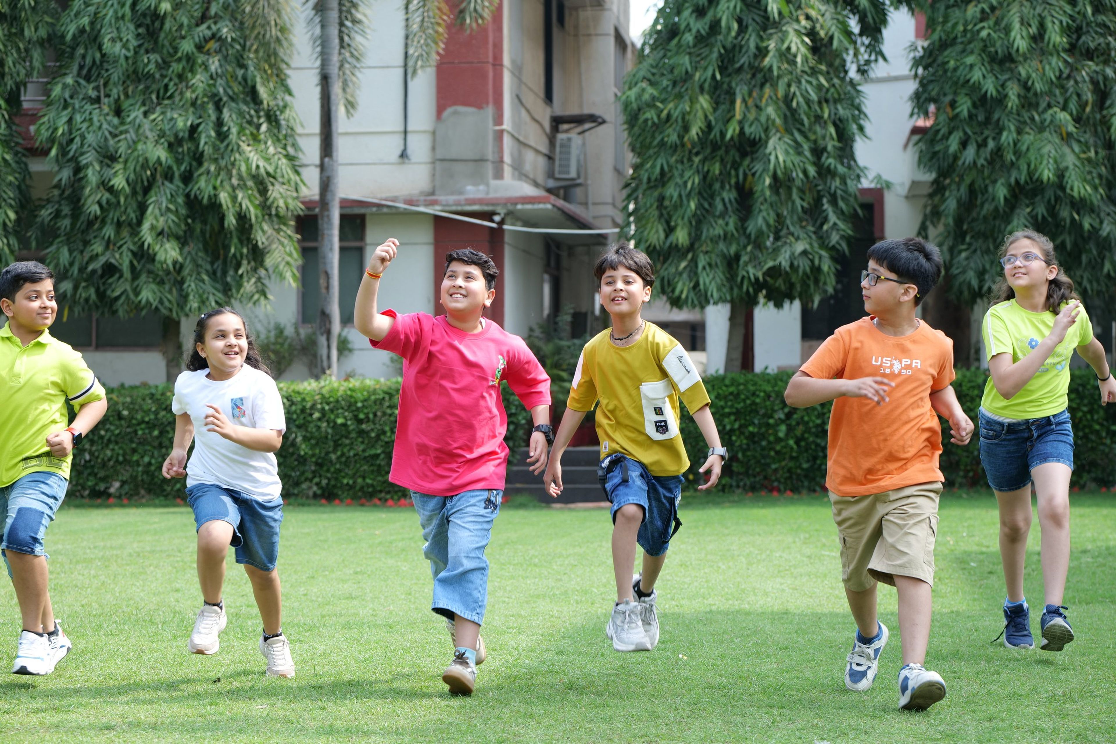 Students running across the school lawn