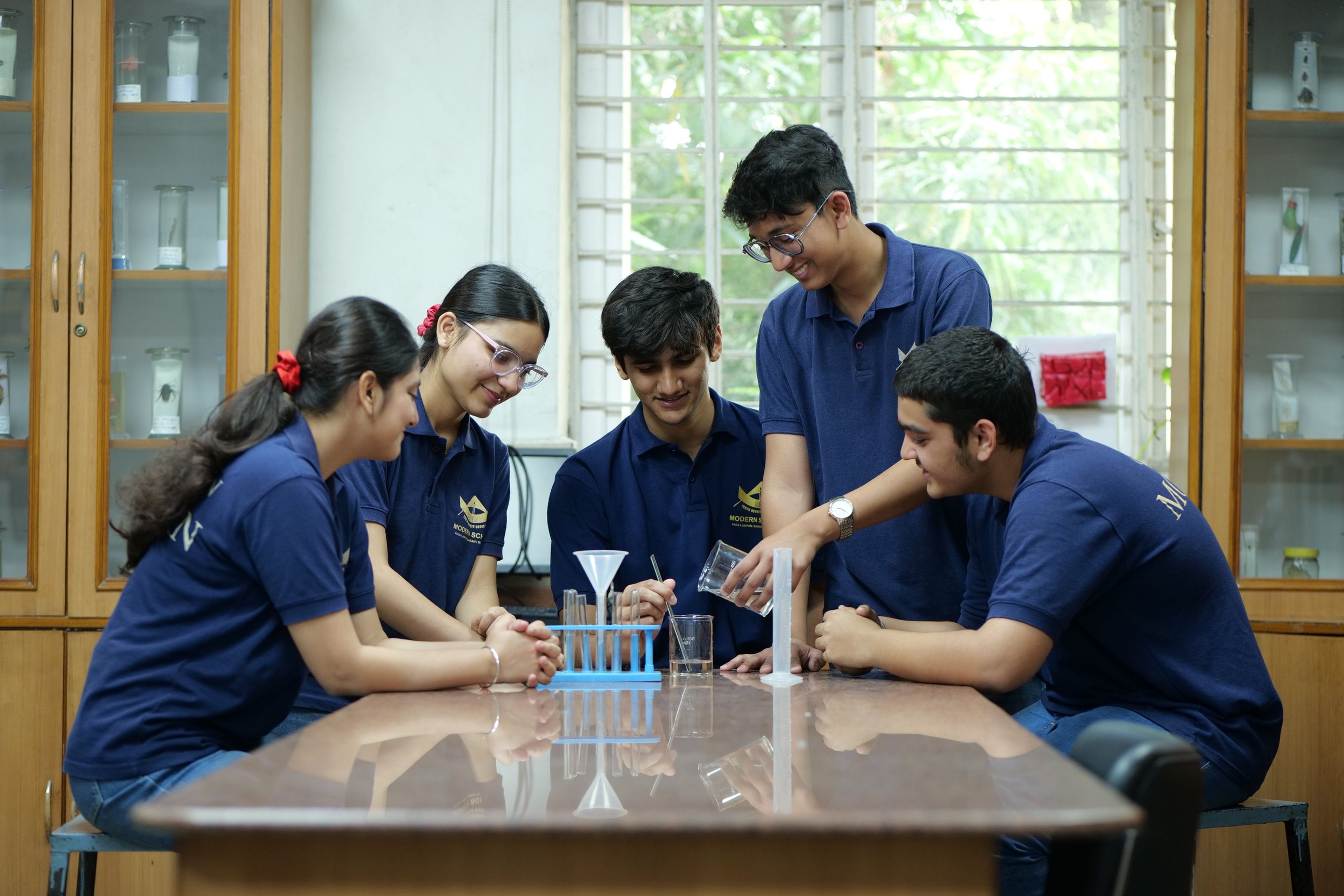 Students measuring liquids during a chemistry practical