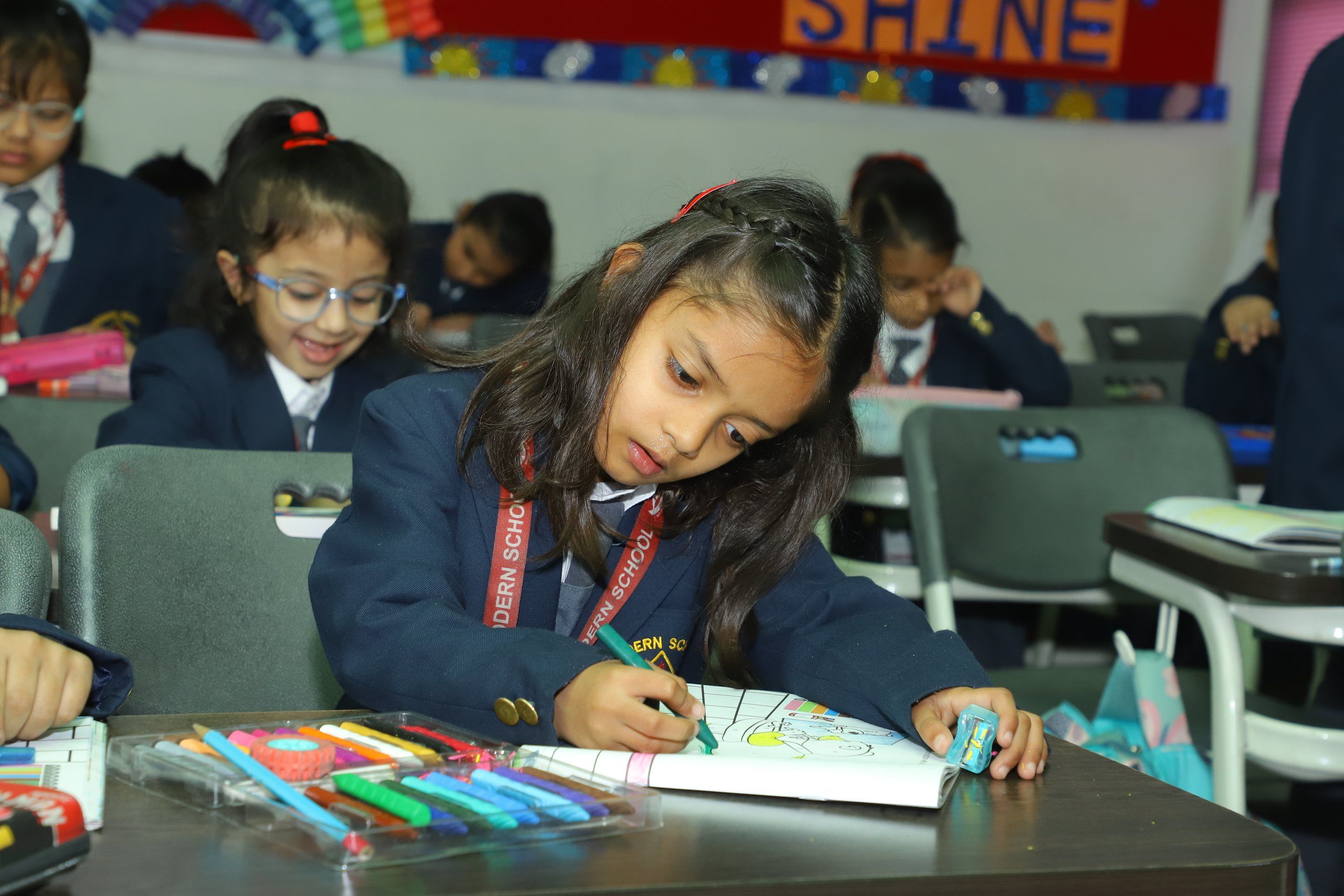 A primary pupil colouring with felt pens in class