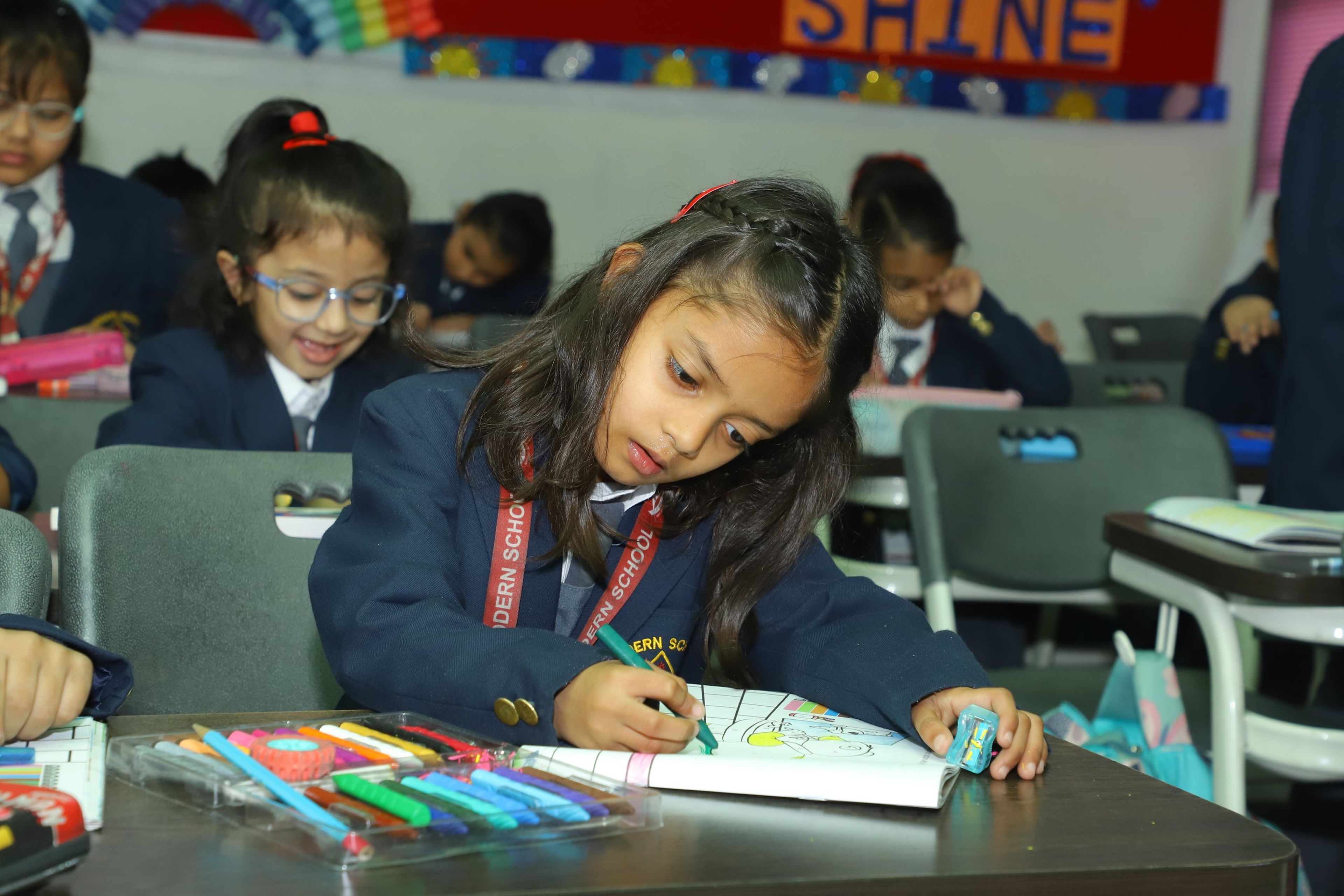 A primary pupil colouring with felt pens in class