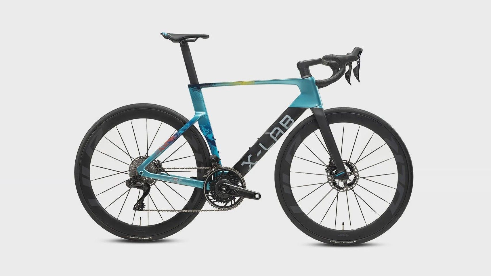 X-LAB AD9 road bike in the XDS Astana team paint, teal and black, side on against a plain studio background