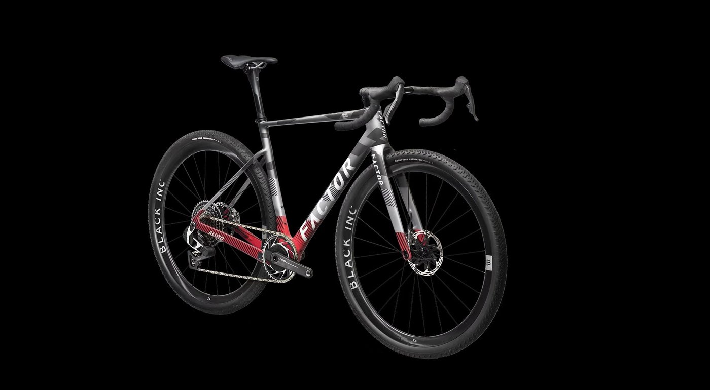 Factor Aluto gravel bike in red and silver, three-quarter view against a black background