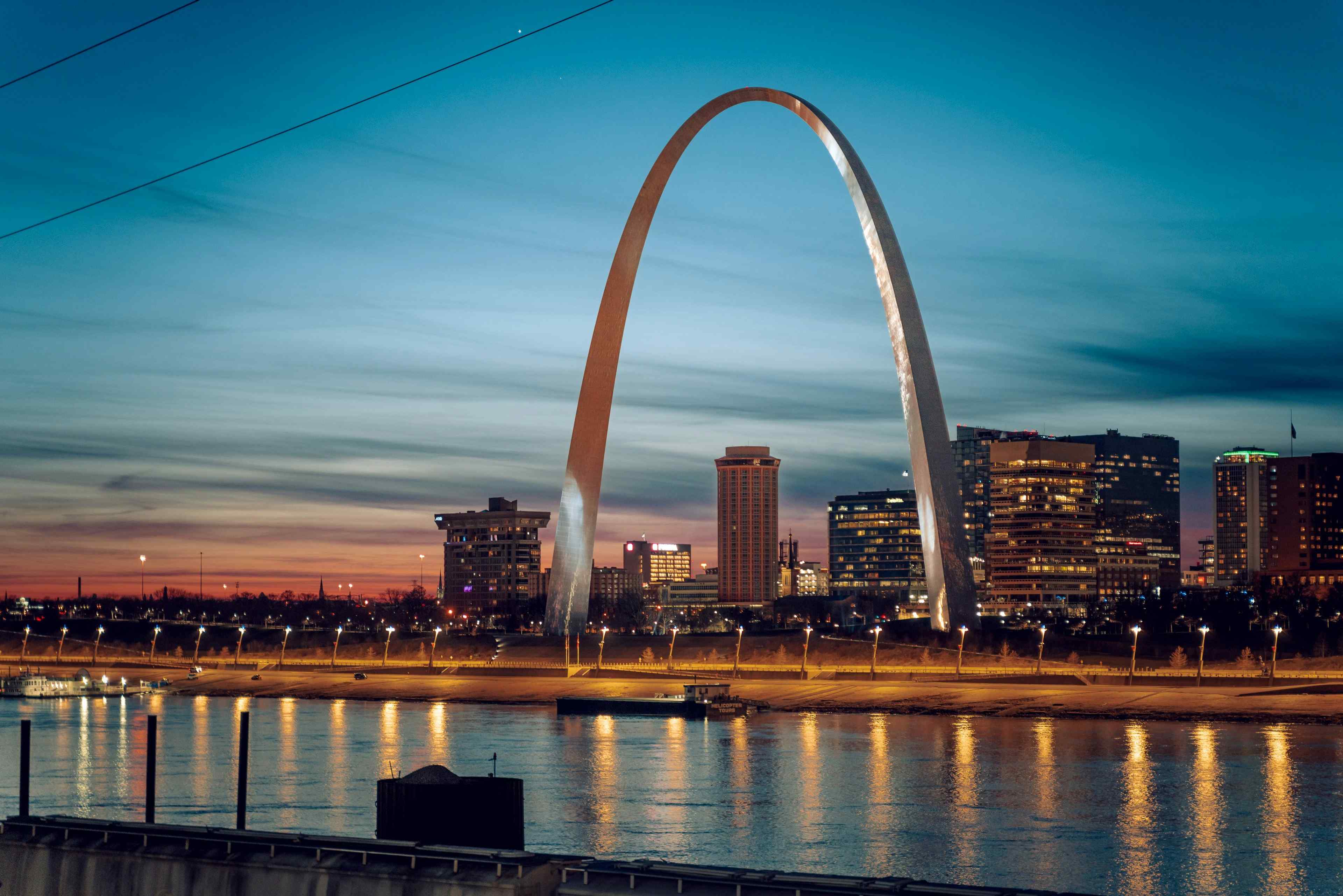 The Gateway Arch over the Mississippi at dusk