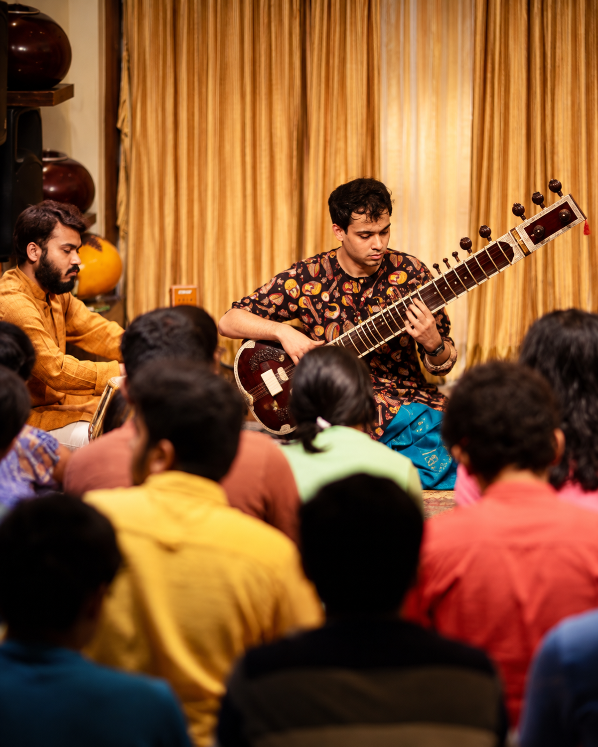 Sweekar teaching Sitar to a group of students
