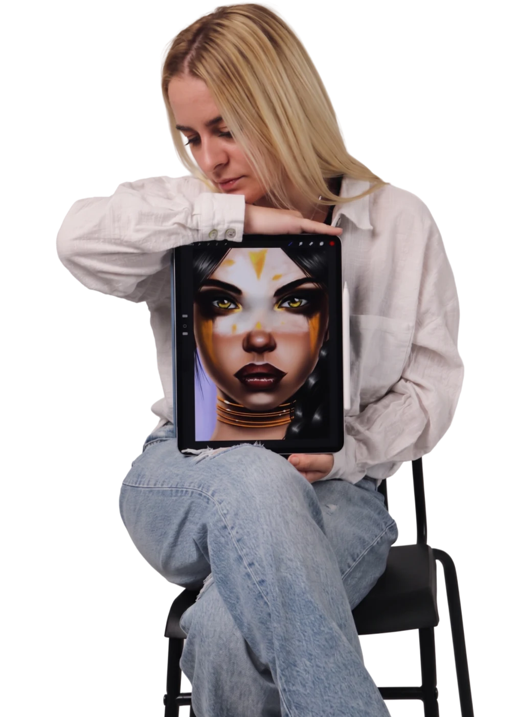 Elena sitting on a chair, holding a tablet with a digital portrait painting