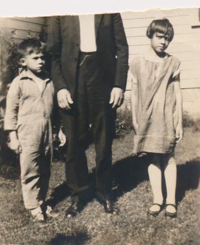 image from Elizabeth and Cowboy with their father, Ernest; his face was torn out of the photo apparently by Cowboy.