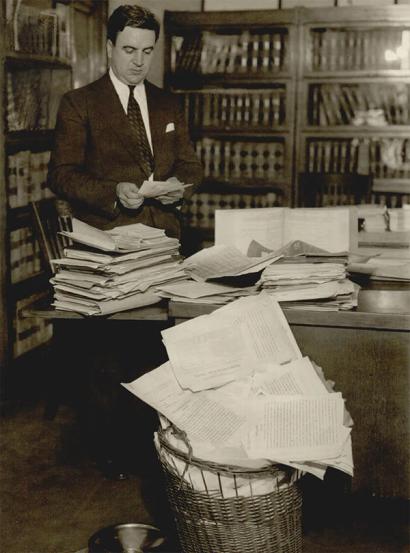 image from Prosecutor Roy St. Lewis reviewing the voluminous Osage murder case files.