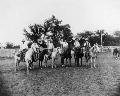 image from Hale (fourth from left) and Grammer (third from left) competing in a roping contest in 1909.