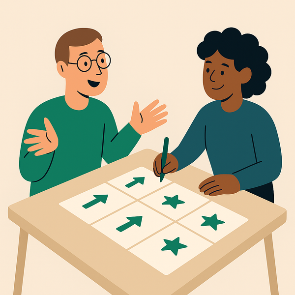 En mann og en kvinne sitter ved et bord og spiller bordspill.