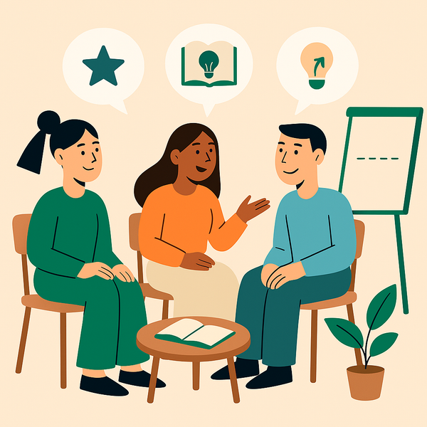 En gruppe mennesker sitter rundt et bord og snakker sammen.