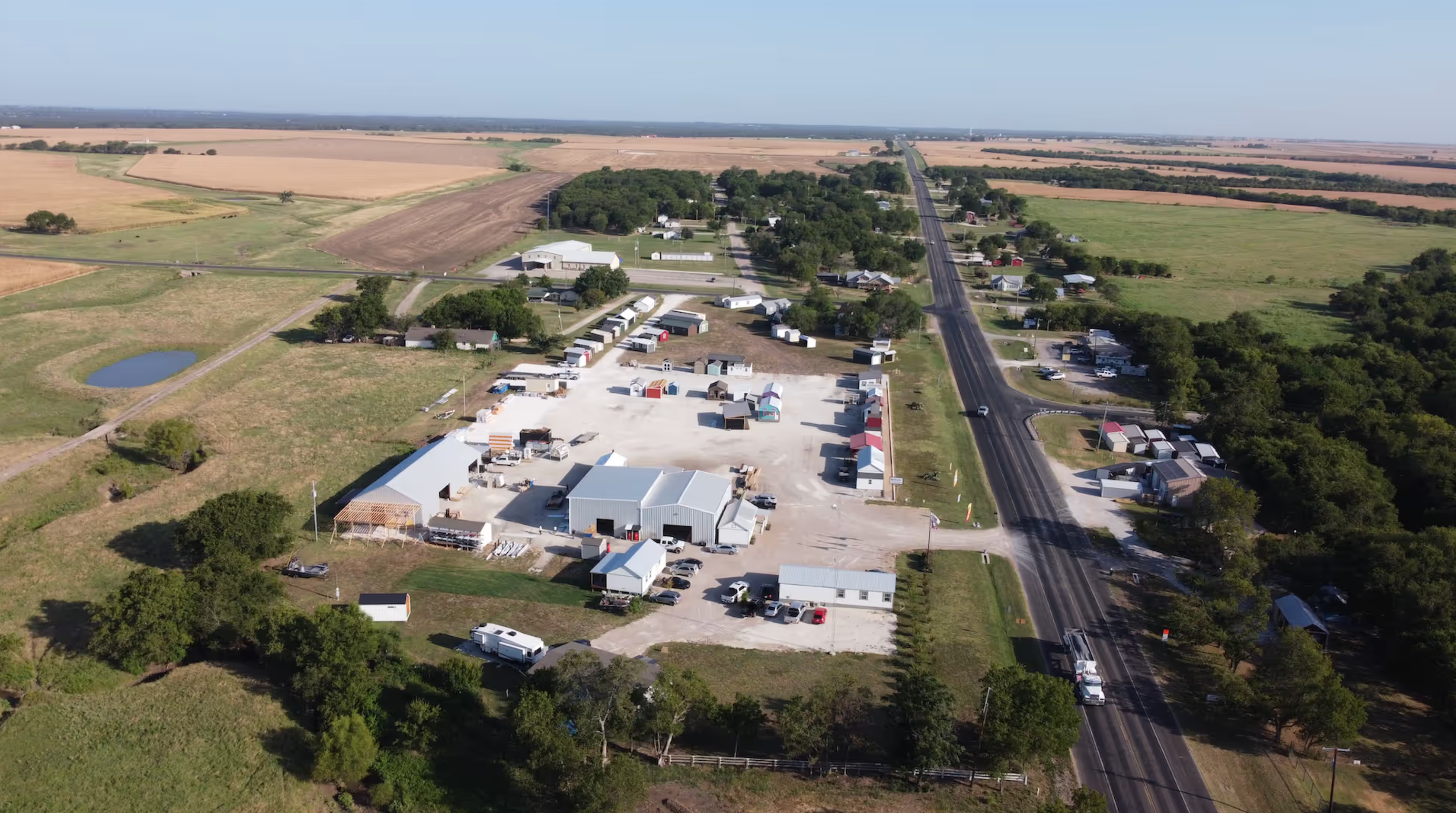 The same company a few years on — a full shop, a real yard, and crews building every day.