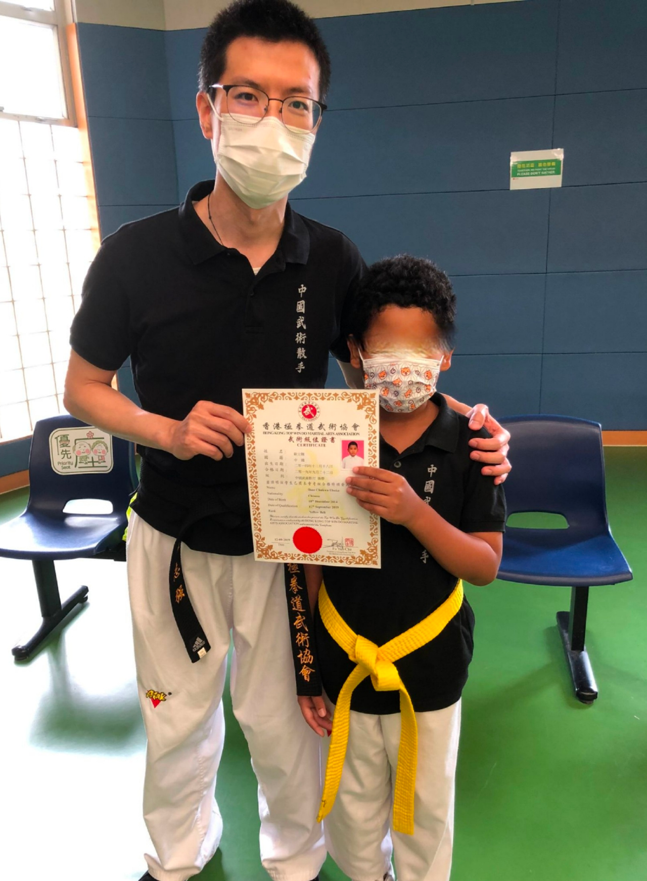 student with coach and certificate