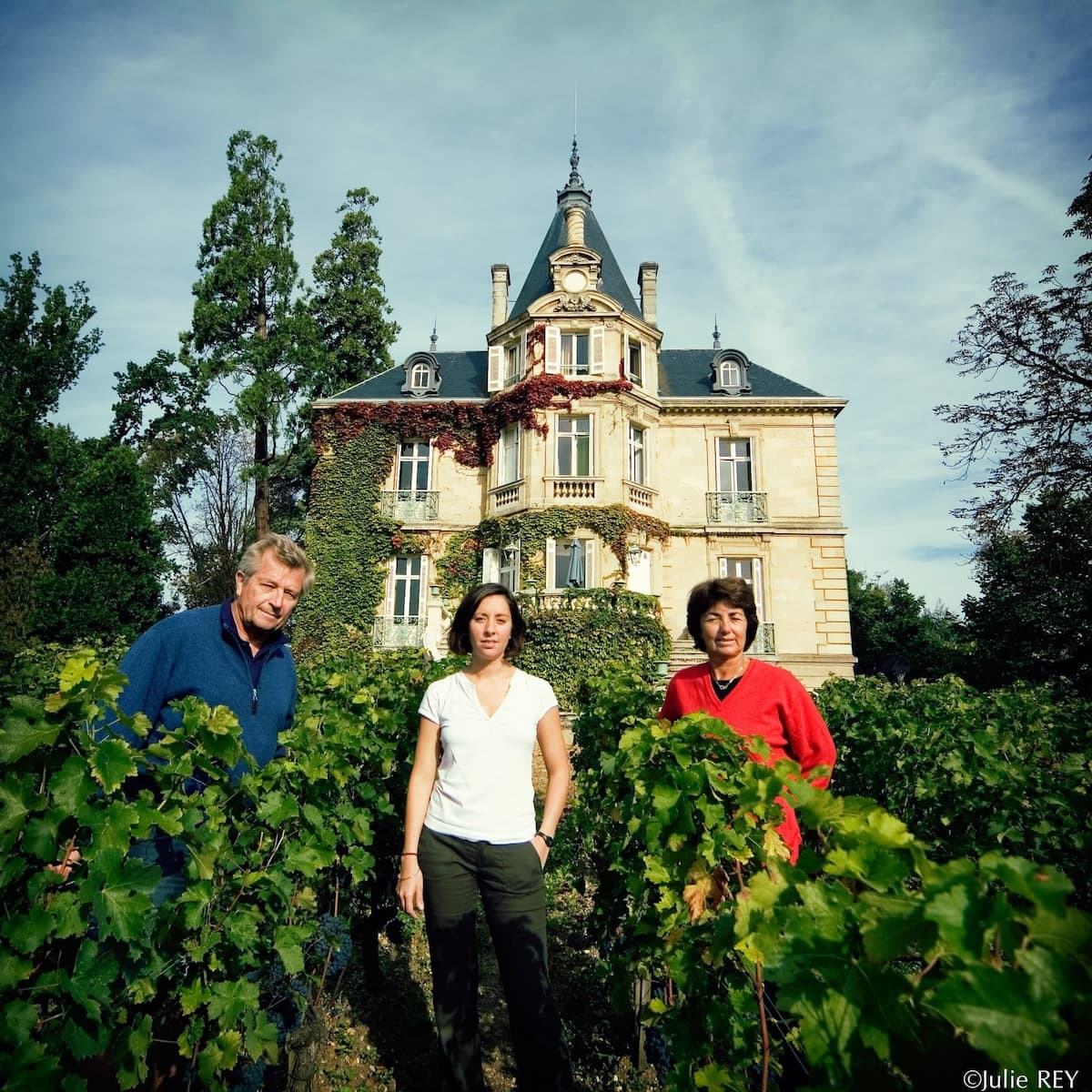 The Chantecaille-Furt family standing in the vines in front of Château Les Carmes Haut-Brion in Pessac-Léognan
