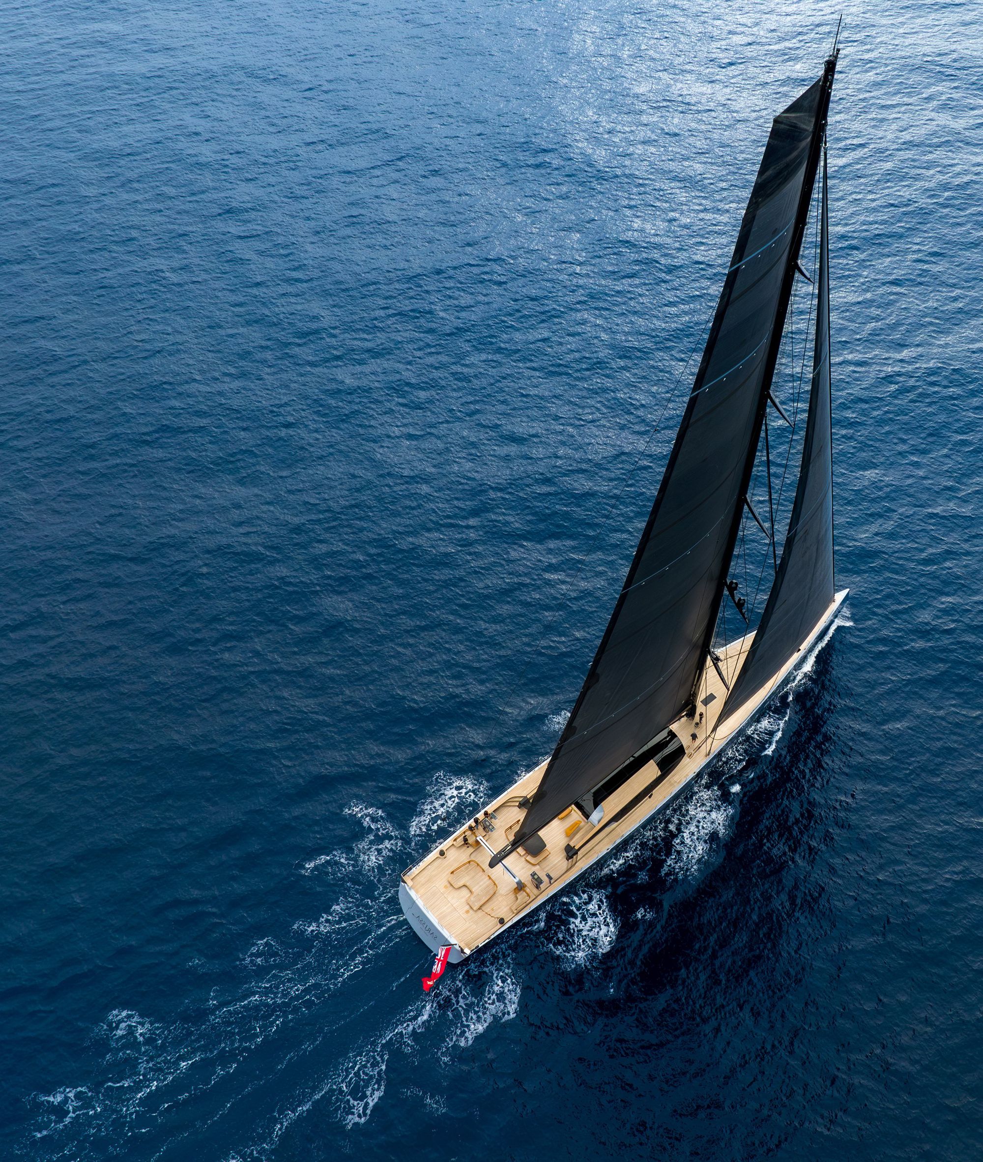 Sarissa with sails unfurled, dynamically heading out to sea