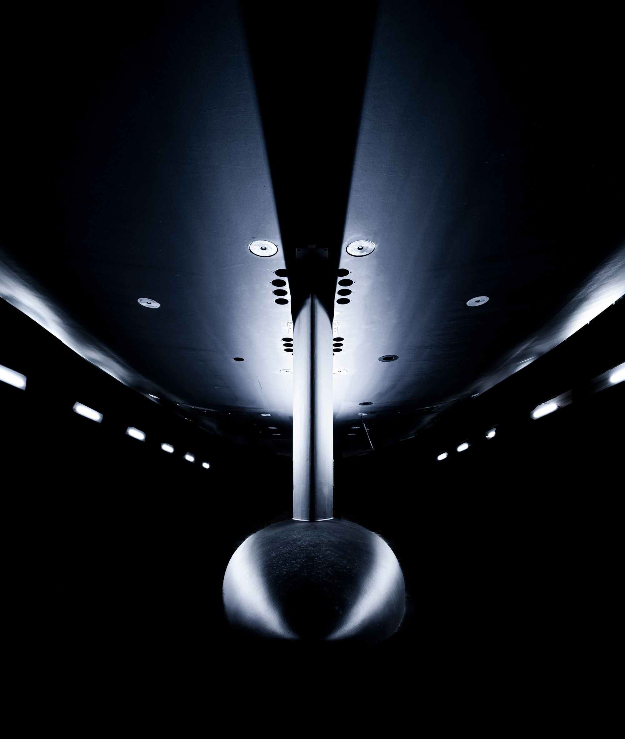 A spectacular image of the yacht's fin and bulb seen from below with contrasting light in the hangar.