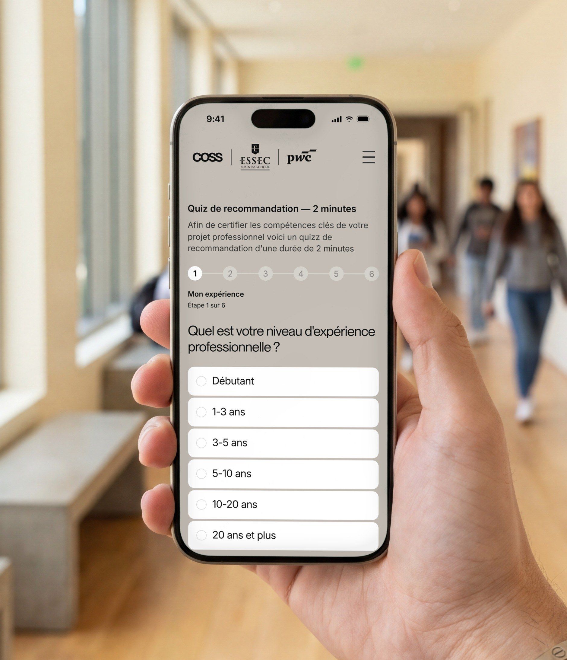 iPhone held in a university corridor, open on the COSS quiz on mobile