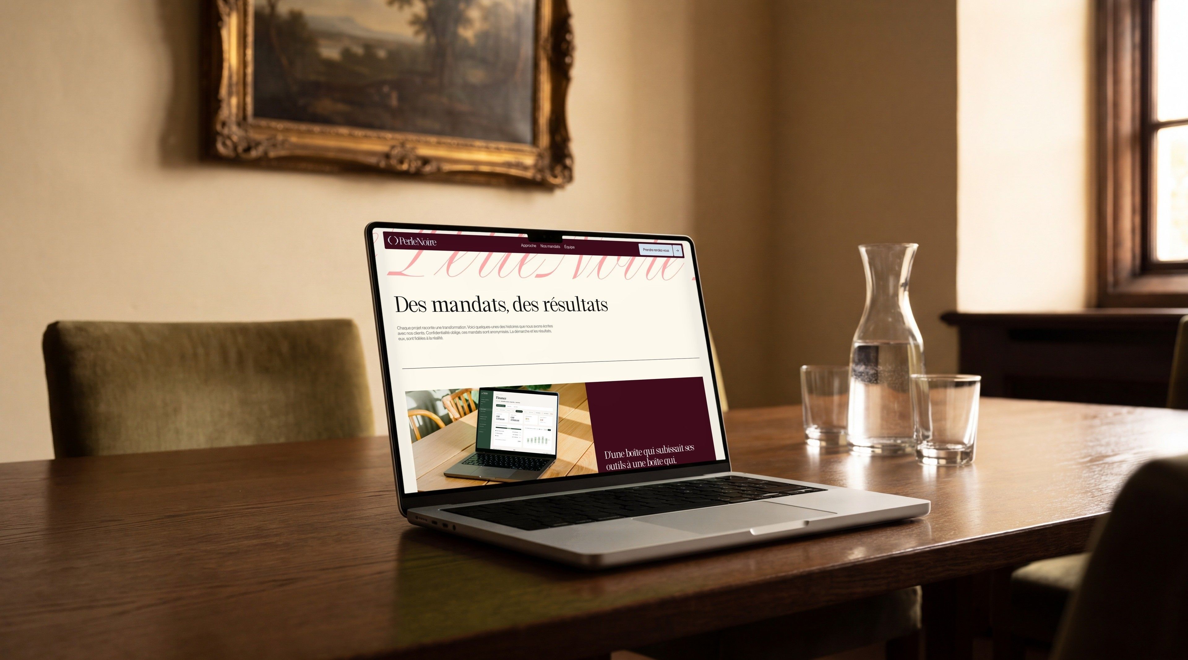 MacBook Pro open on Perle Noire's “Engagements, results” page, on a meeting table