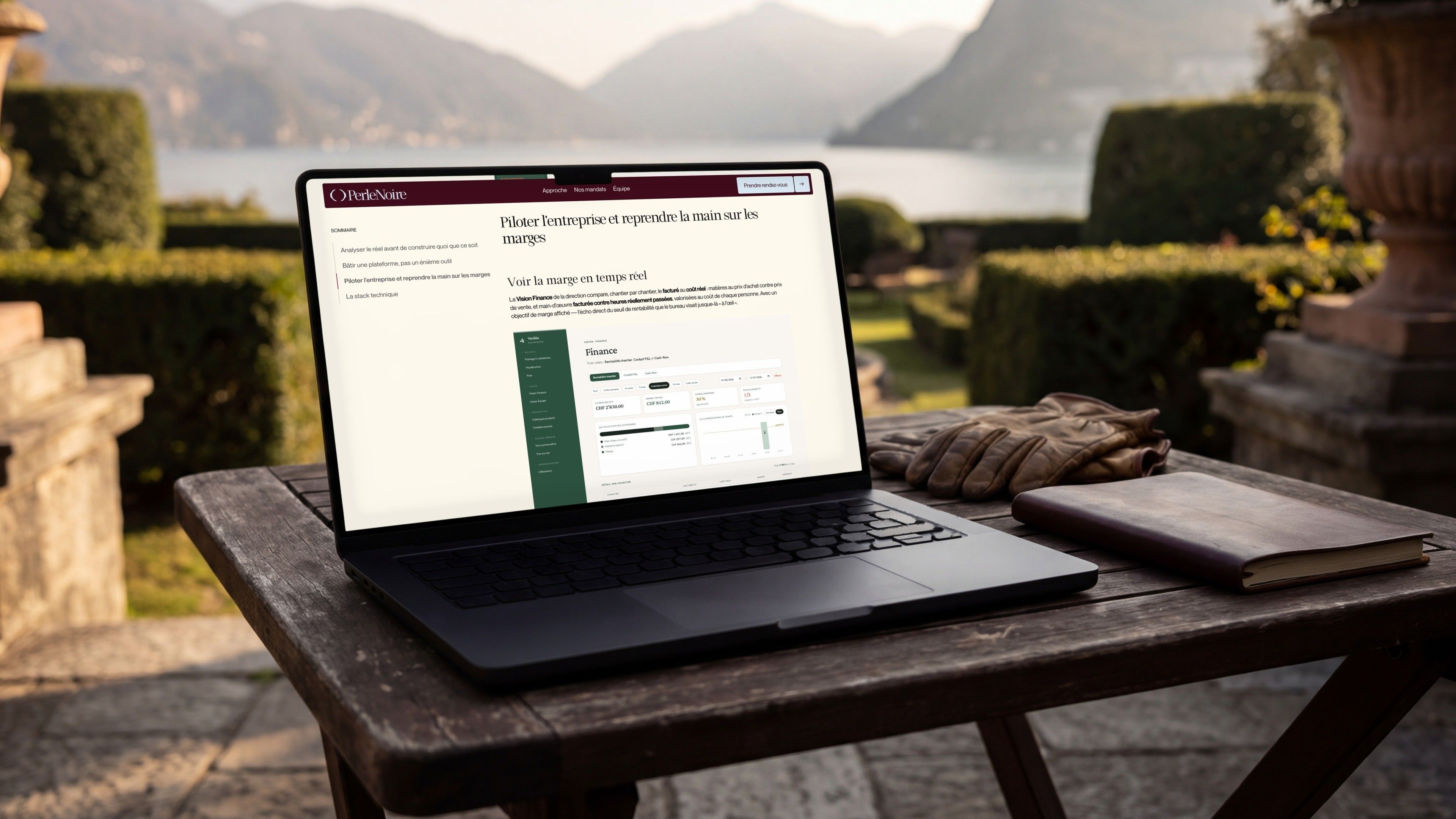MacBook Pro on a lakeside terrace, open on the Perle Noire case study and its Finance dashboard