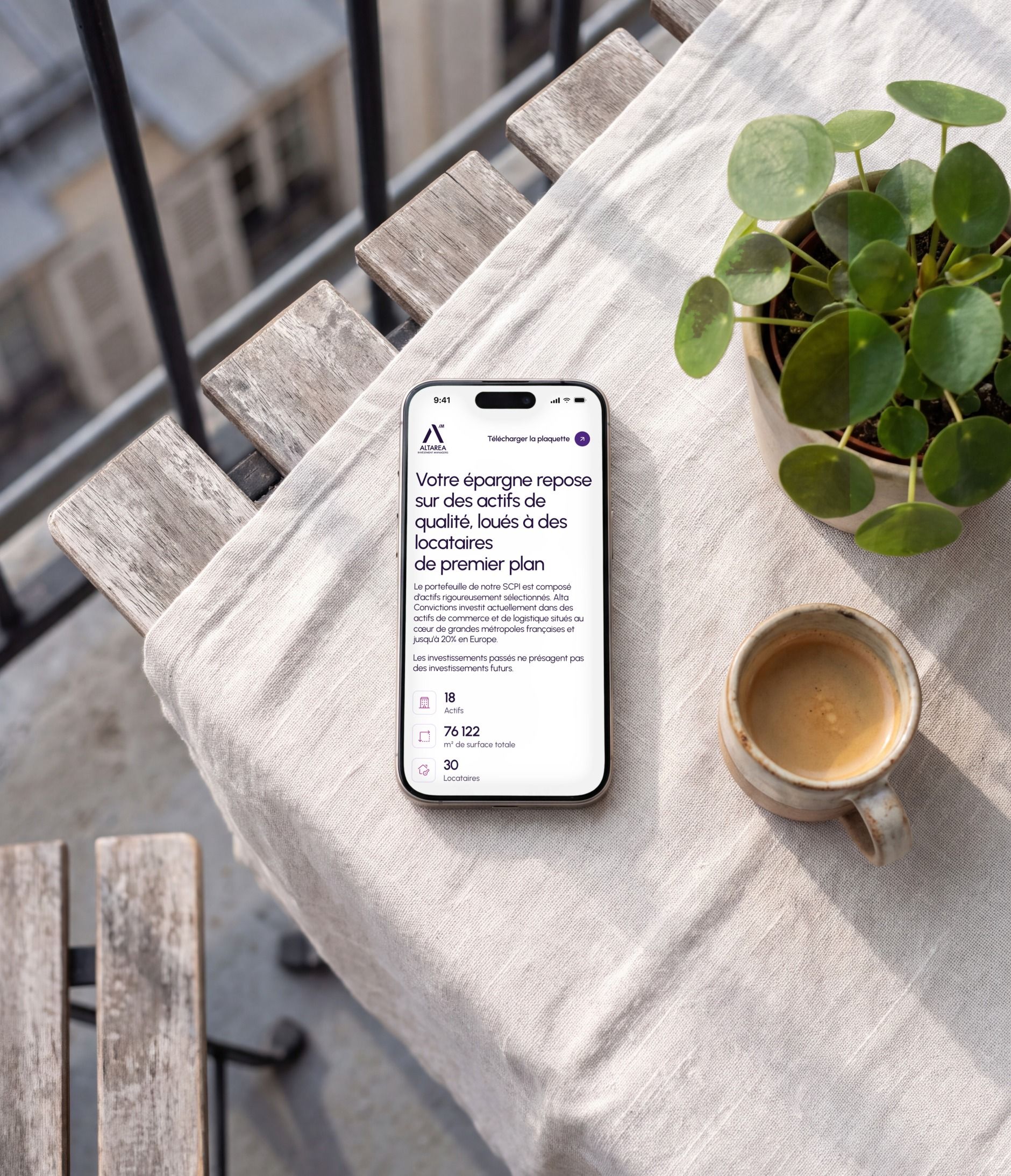 iPhone 16 Pro on a balcony table, open on the portfolio section on mobile