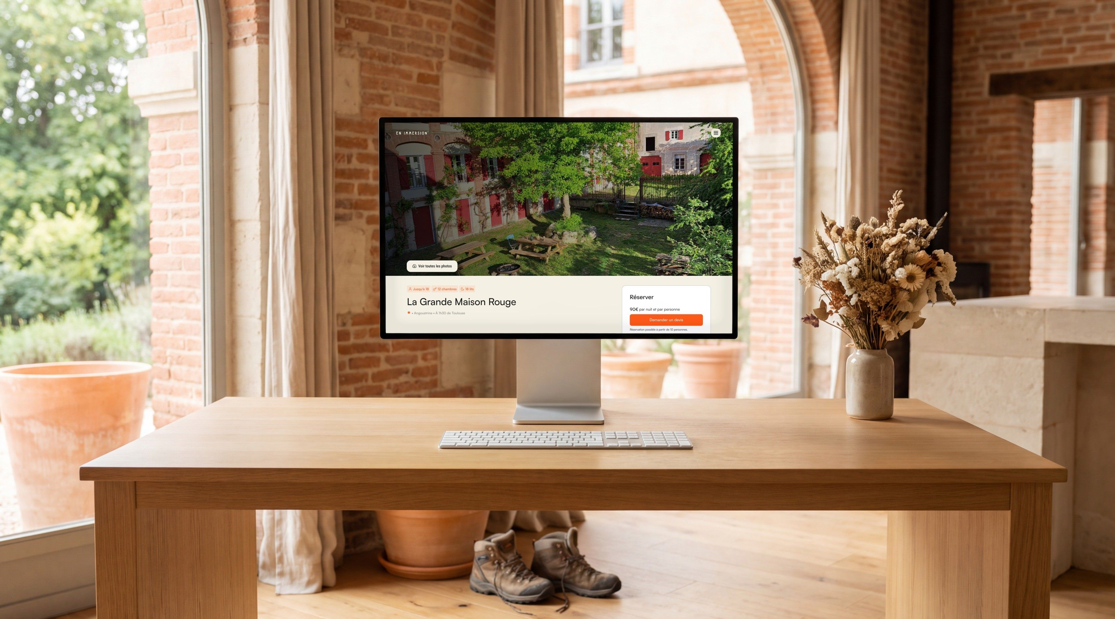 Pro Display XDR open on the Grande Maison Rouge page, in a brick office