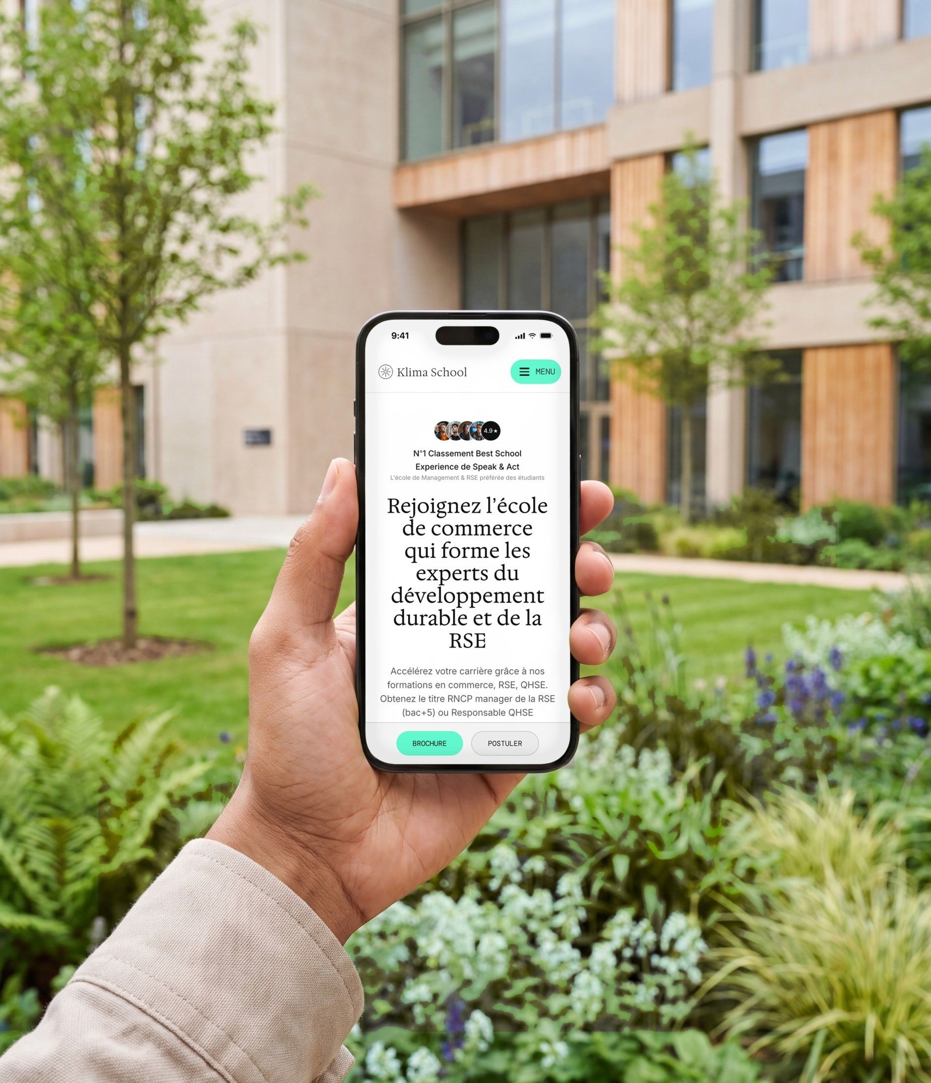 iPhone 16 Pro open on the Klima School mobile home page, in a campus garden