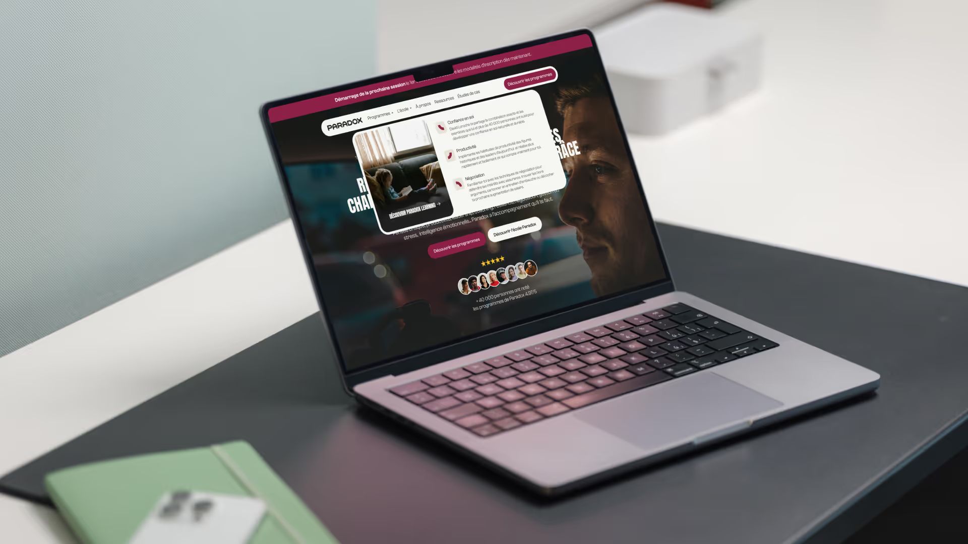 Laptop showing the Paradox website with an open dropdown menu over a dark hero image