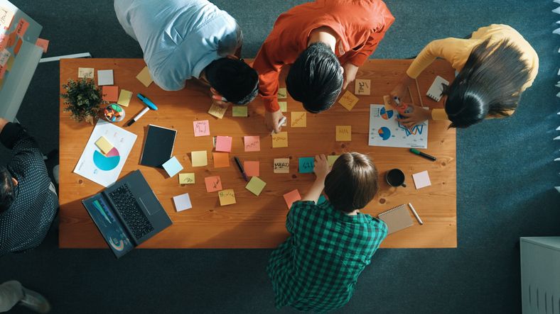 Top view of team brainstorming idea and writing plan at notes. Convocation. stock photo