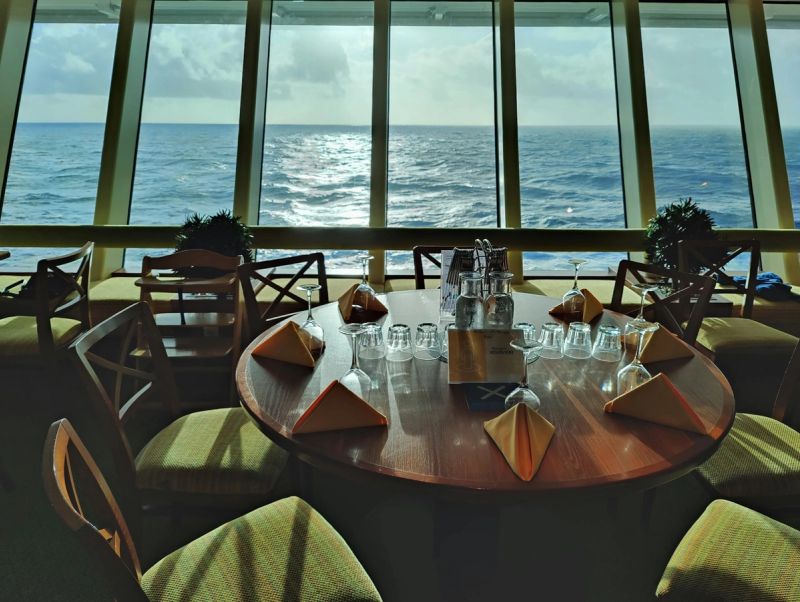 Cruise ship main dining room with panoramic ocean views