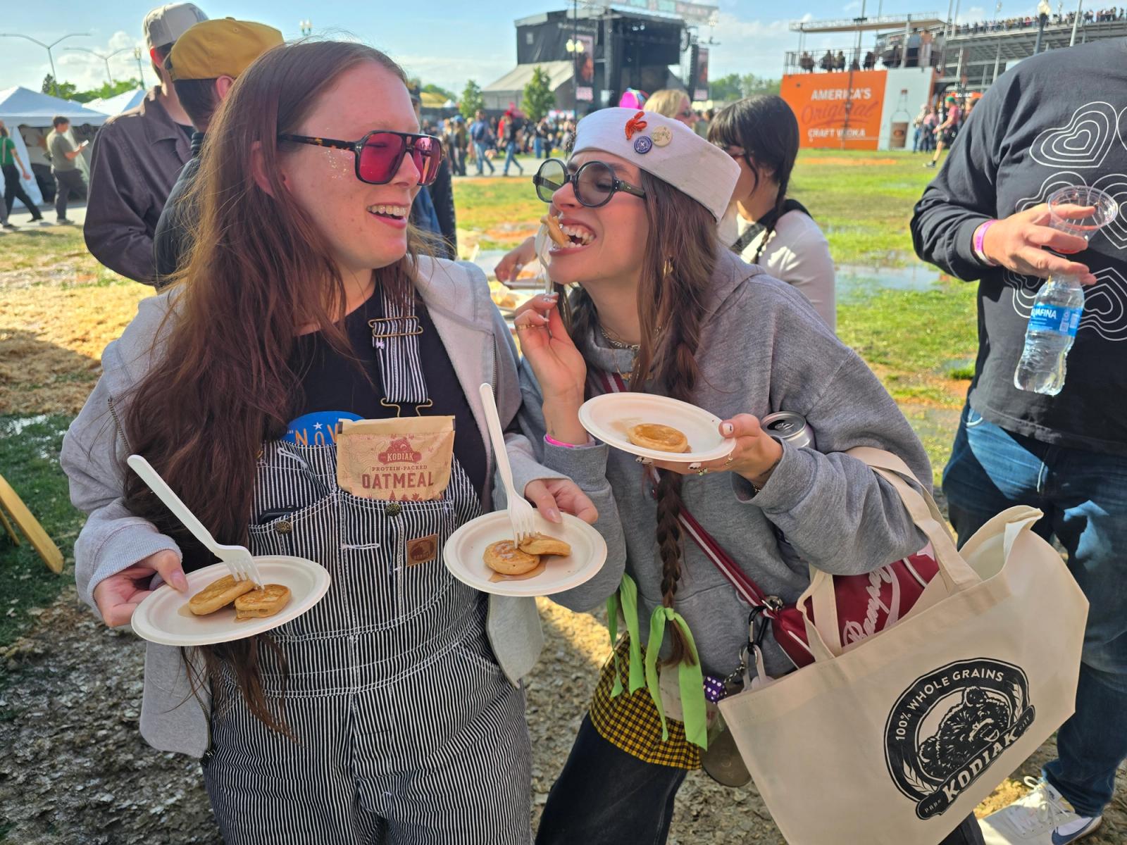 Two event attendees enjoying Kodiak Cakes Samples