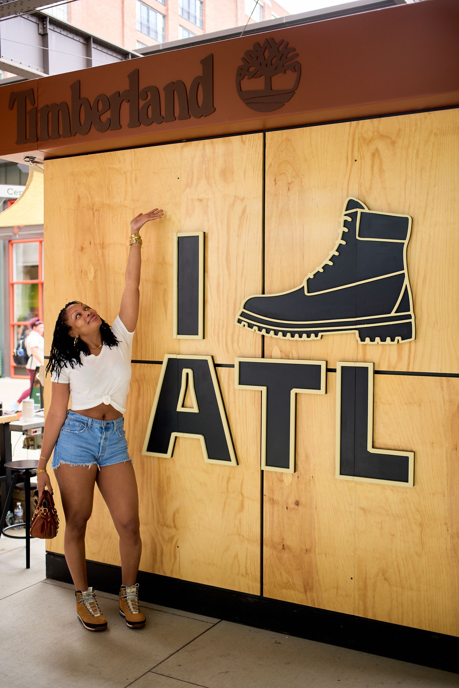 Consumer posing in front of I Boot ATL Timberland Wall at Timberland Pop Up Experiential Activation