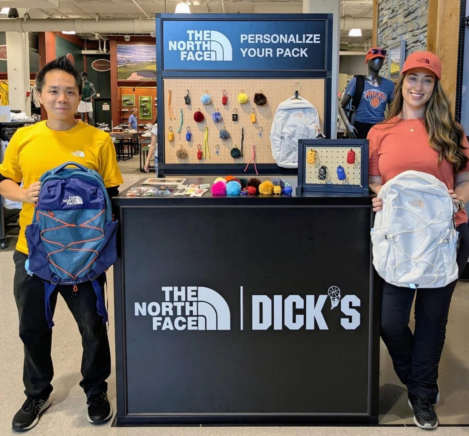 a boy and a girl holding a backpack