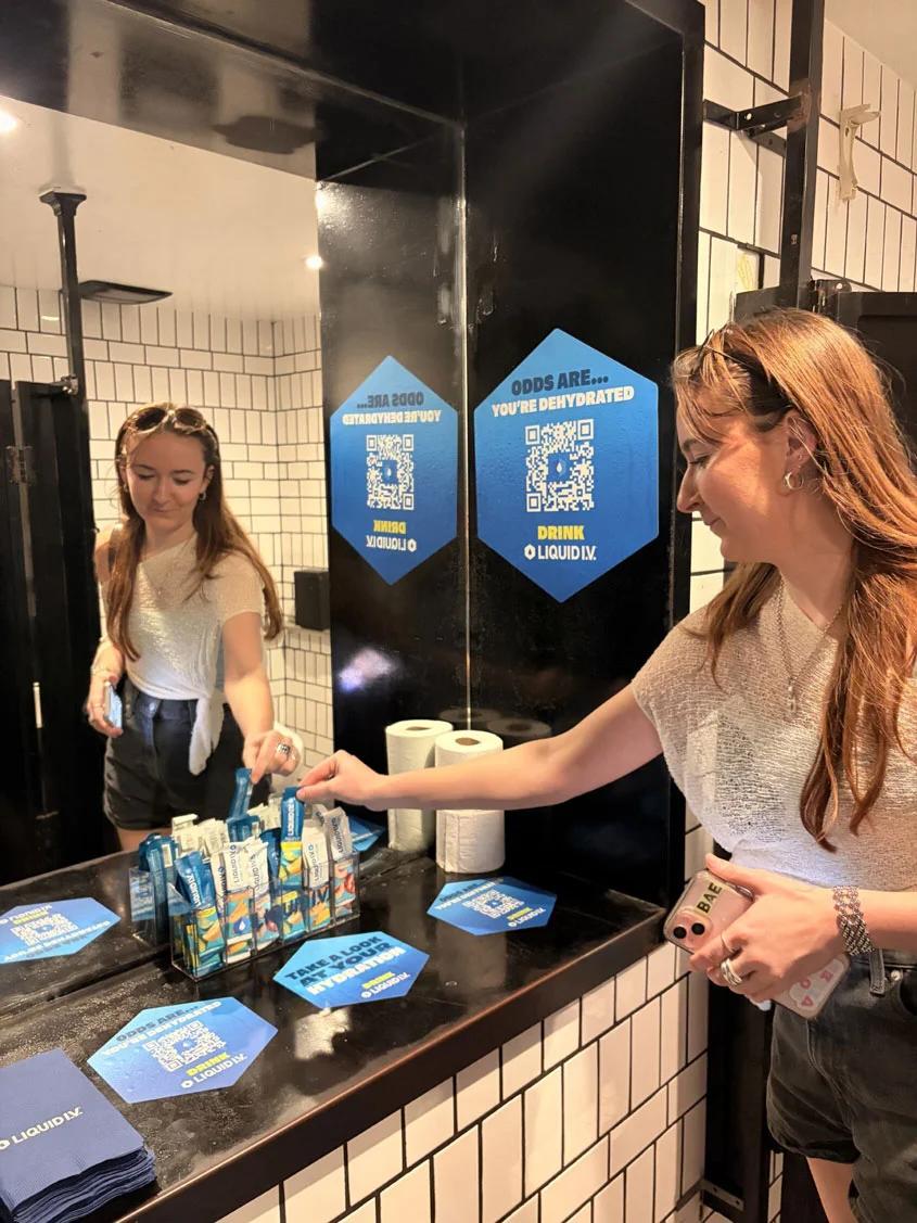 women looking at a sink with products