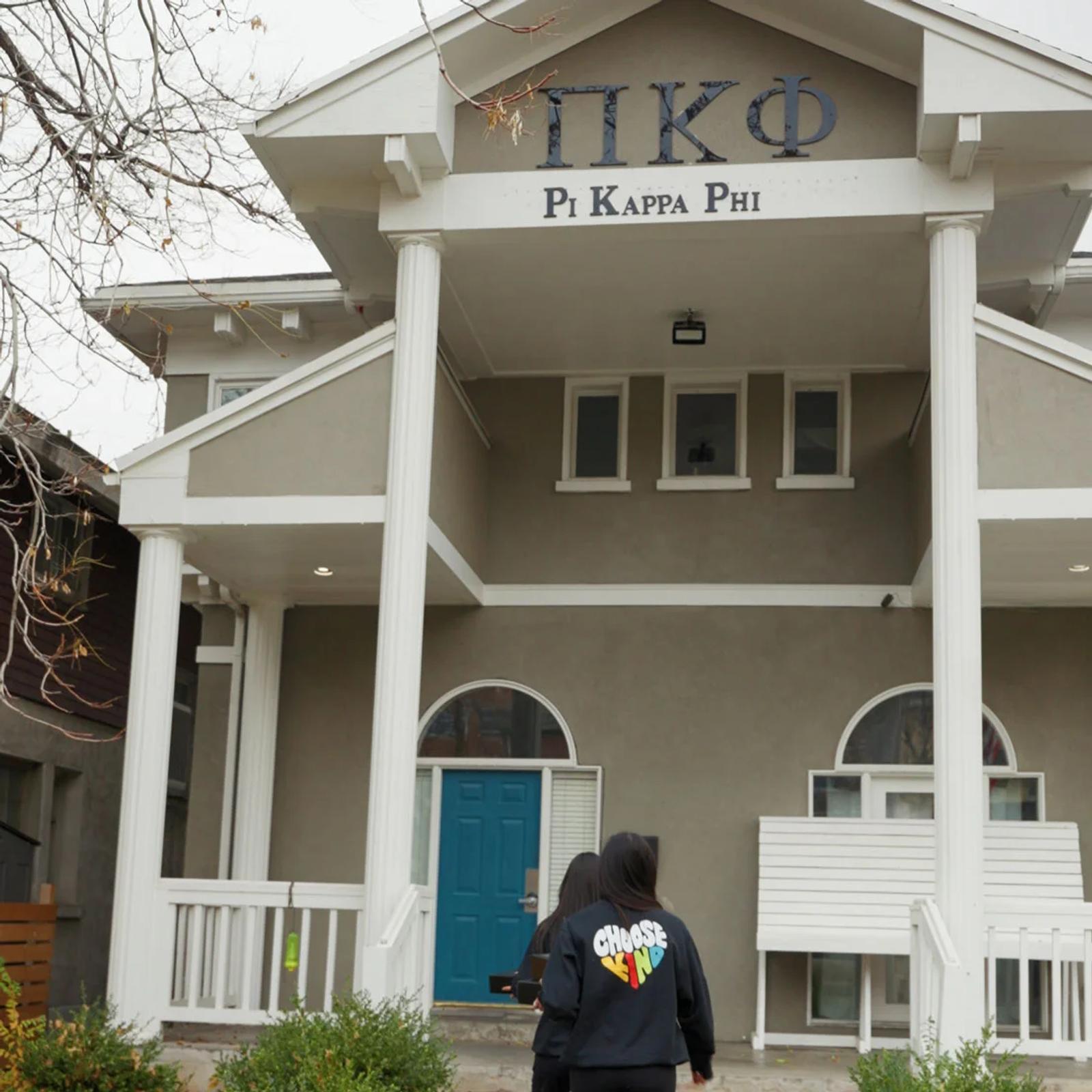 Image of students walking toward a Pi Kappa Phi fraternity house wearing Choose Kind branded sweatshirts
