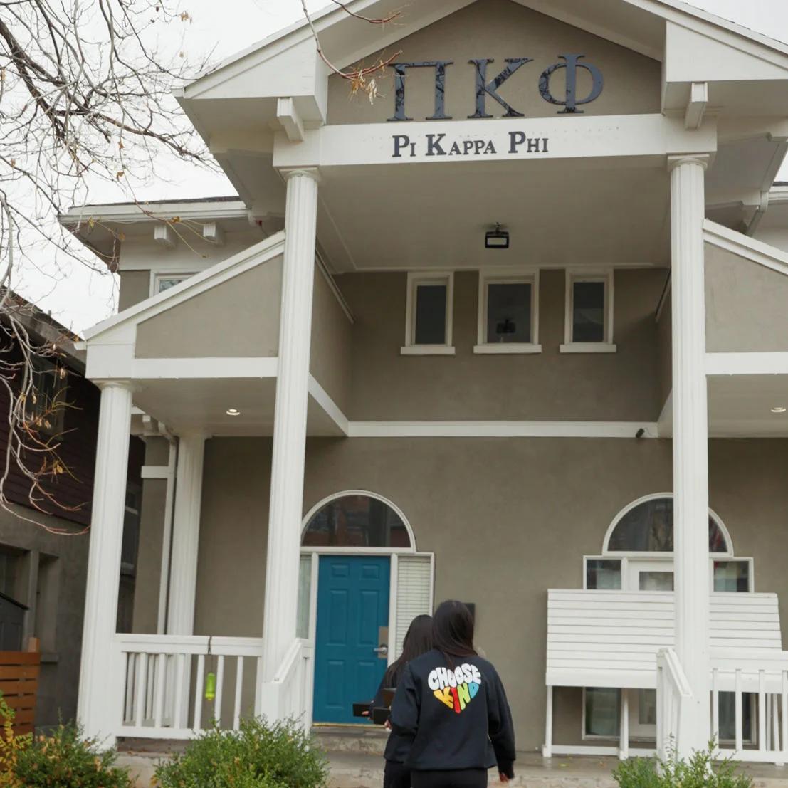 Image of students walking toward a Pi Kappa Phi fraternity house wearing Choose Kind branded sweatshirts